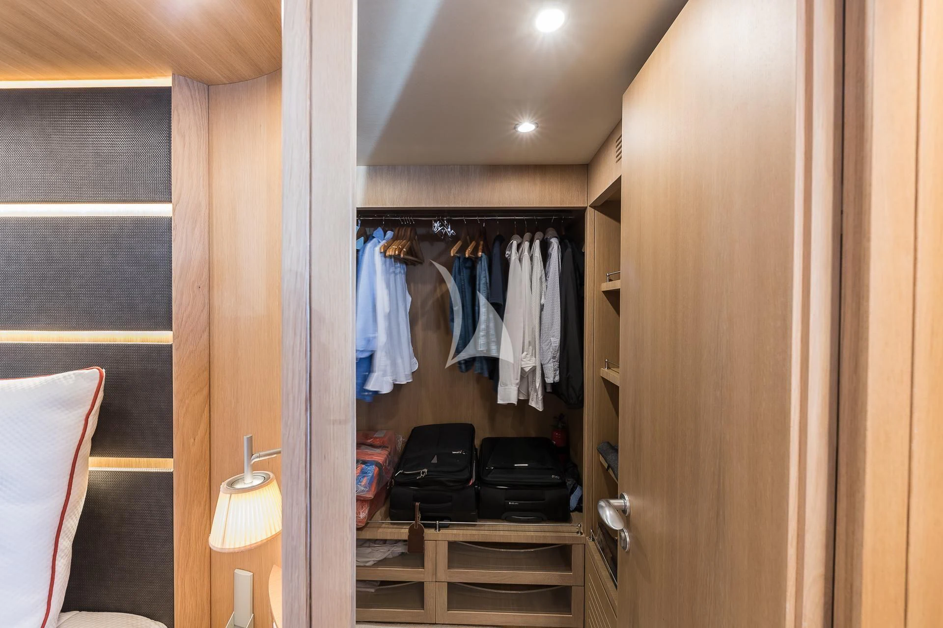 a closet with clothes on the wall aboard POBEDY I Yacht for Sale