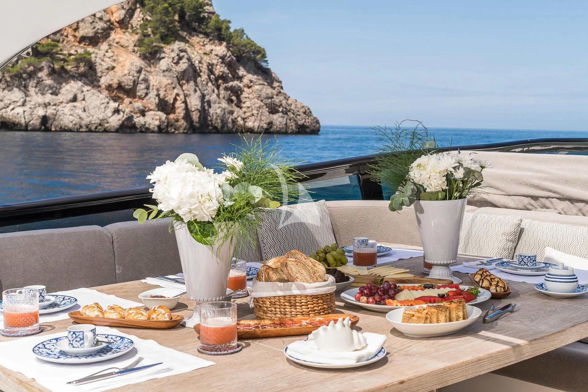a table with food and drinks on it aboard POBEDY I Yacht for Sale