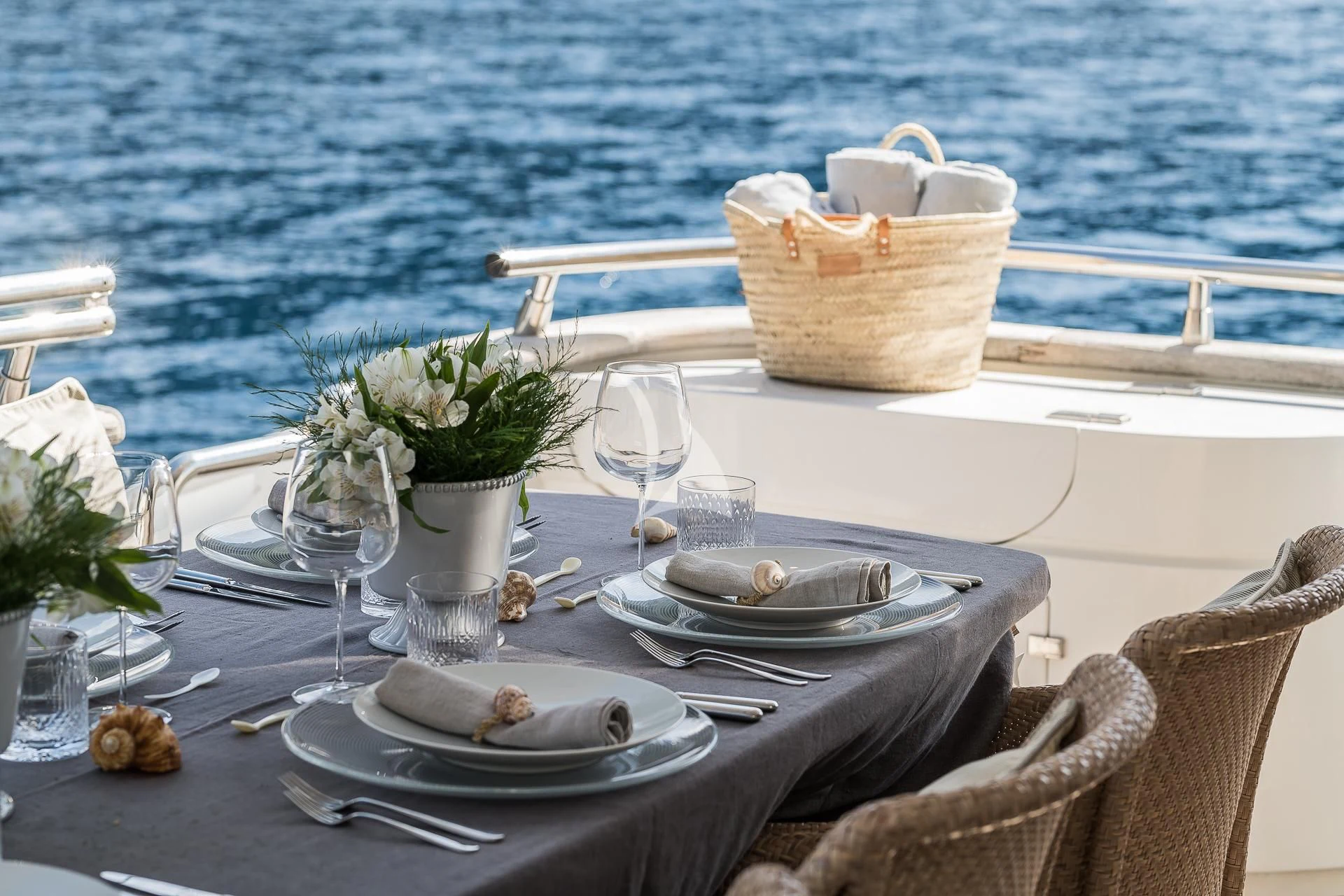 a table set with plates and flowers aboard POBEDY I Yacht for Sale