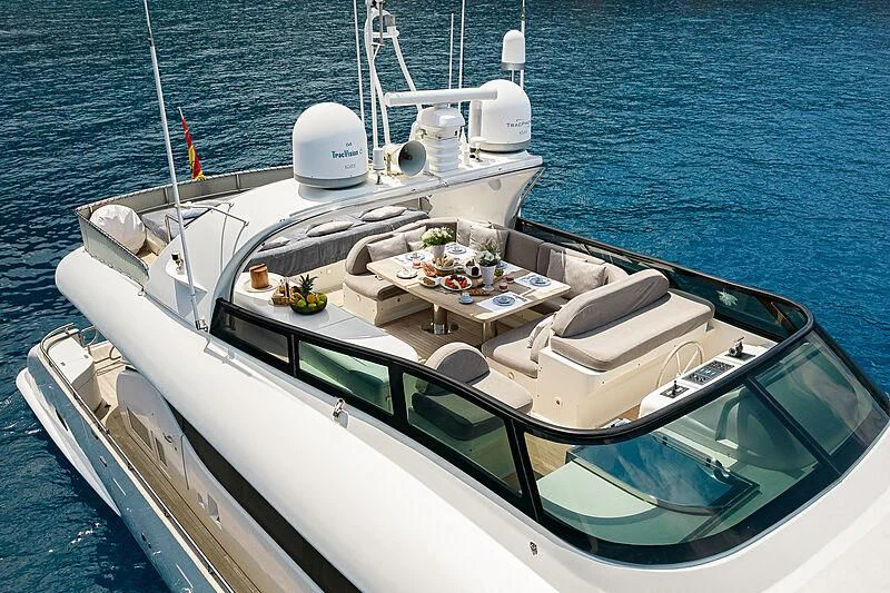 a boat with a table and chairs on it aboard POBEDY I Yacht for Sale