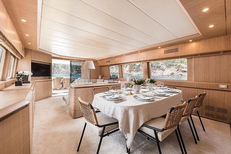 a dining room with a table and chairs aboard POBEDY I Yacht for Sale