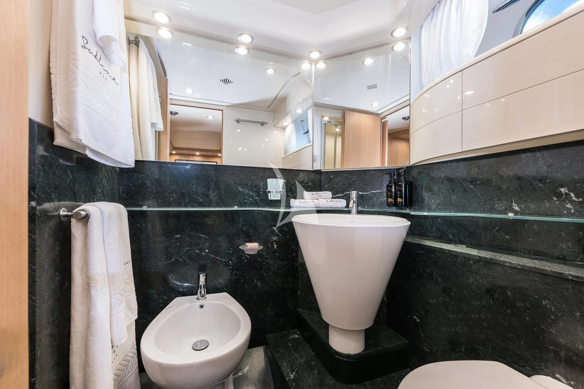 a bathroom with a large mirror aboard POBEDY I Yacht for Sale