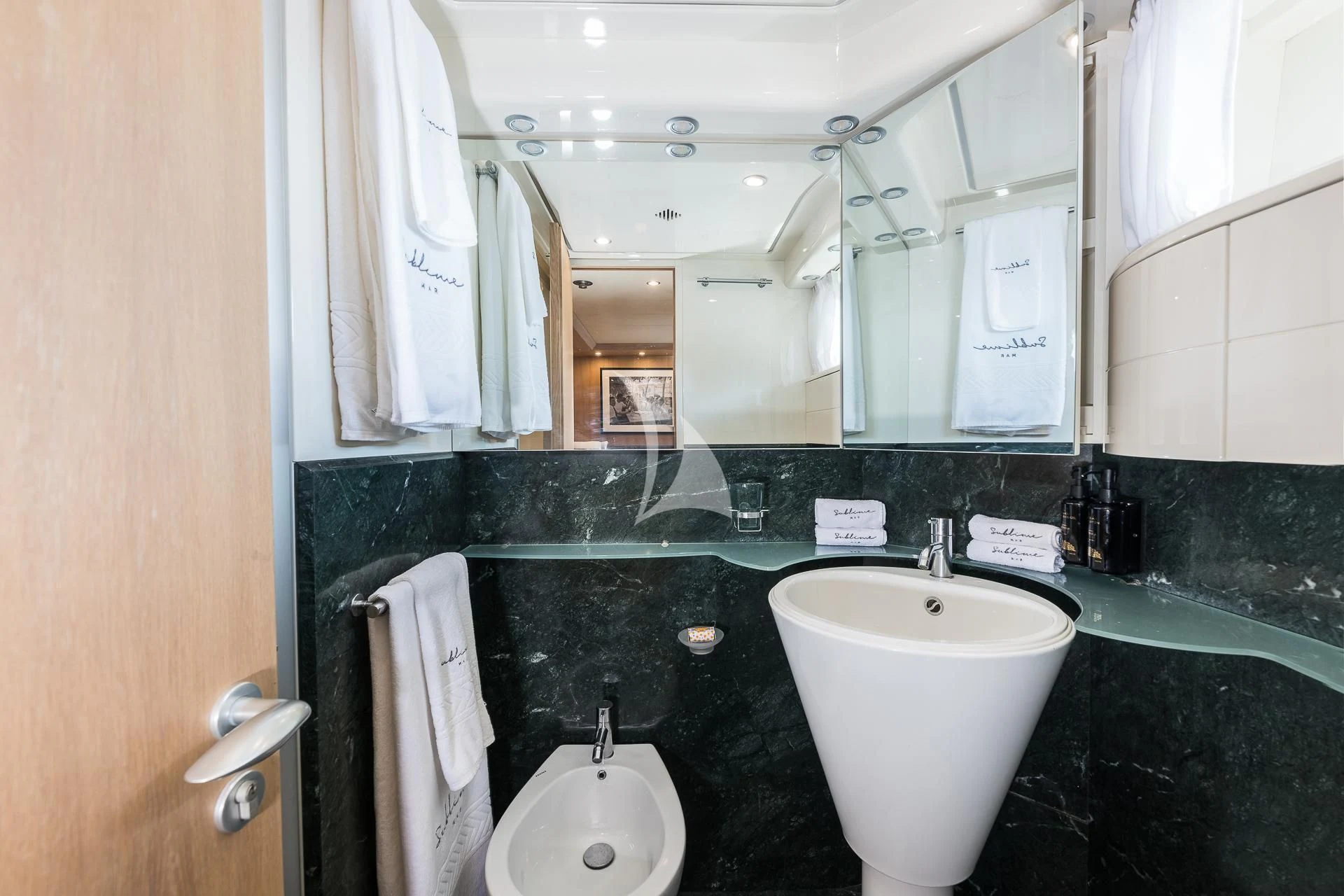 a bathroom with sinks and mirrors aboard POBEDY I Yacht for Sale
