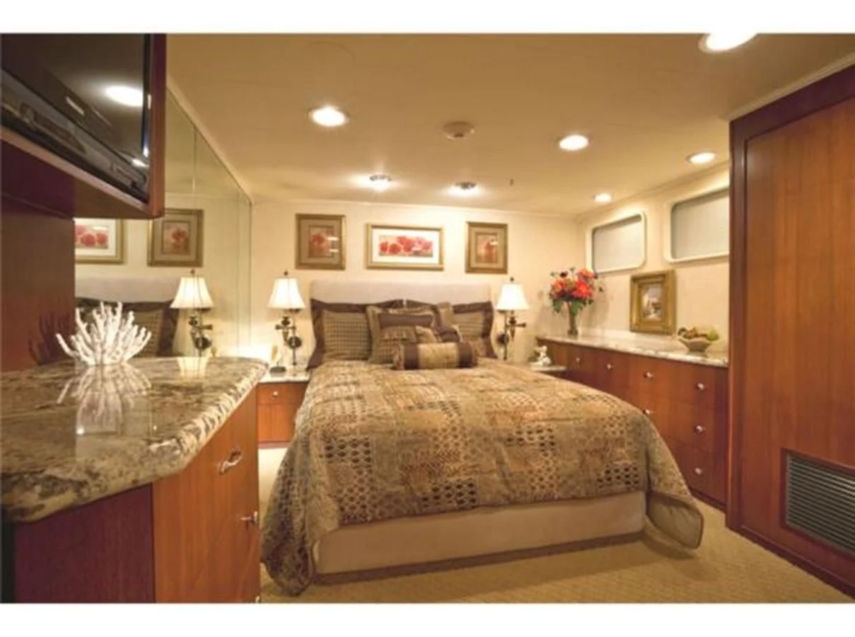 a bedroom with a bed and a television aboard SHENANDOAH Yacht for Sale