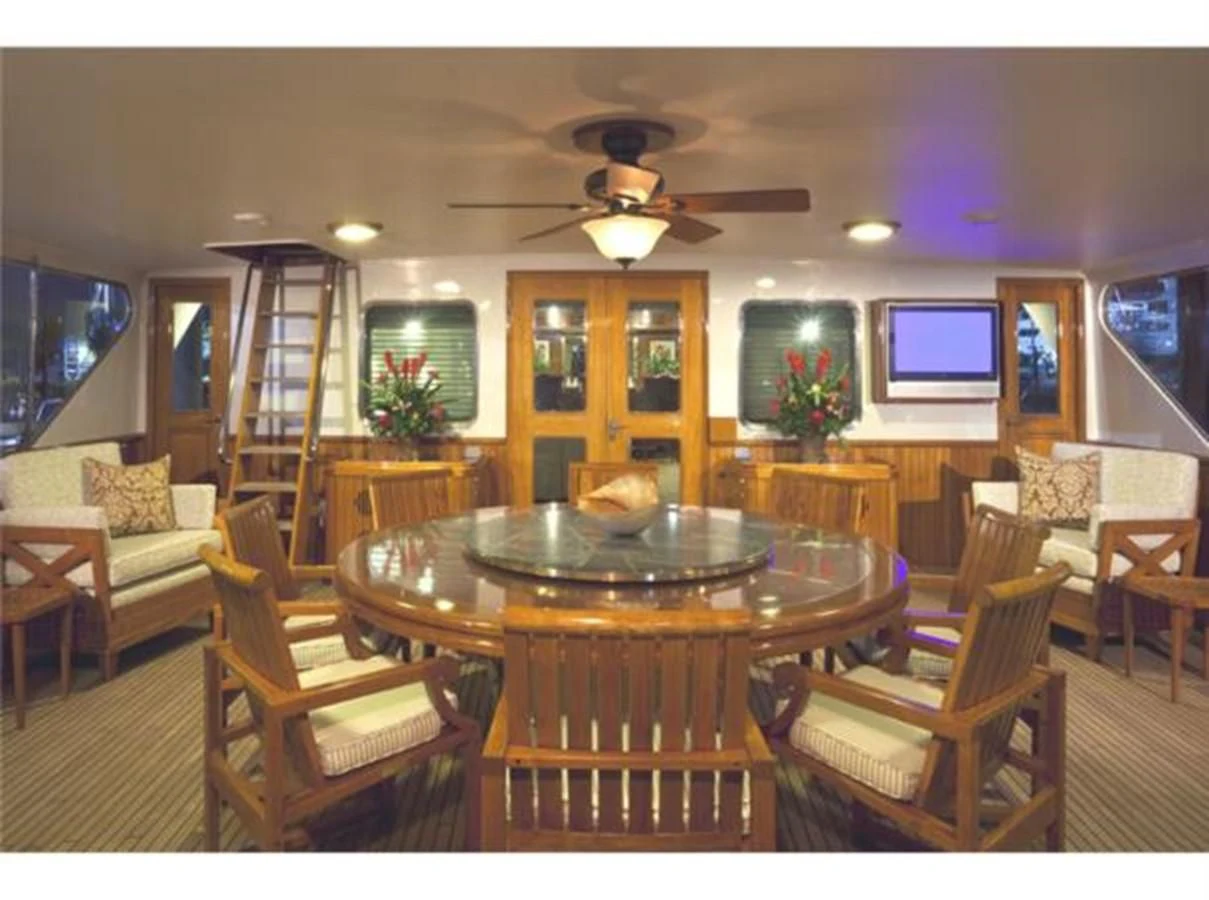 a living room with a table and chairs aboard SHENANDOAH Yacht for Sale
