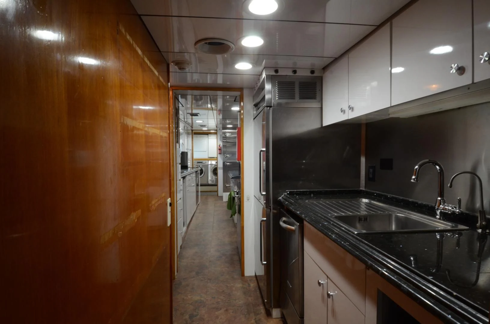 a kitchen with black counter tops aboard SHENANDOAH Yacht for Sale
