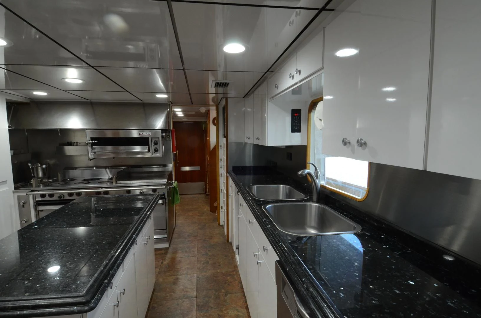 a kitchen with black counters aboard SHENANDOAH Yacht for Sale