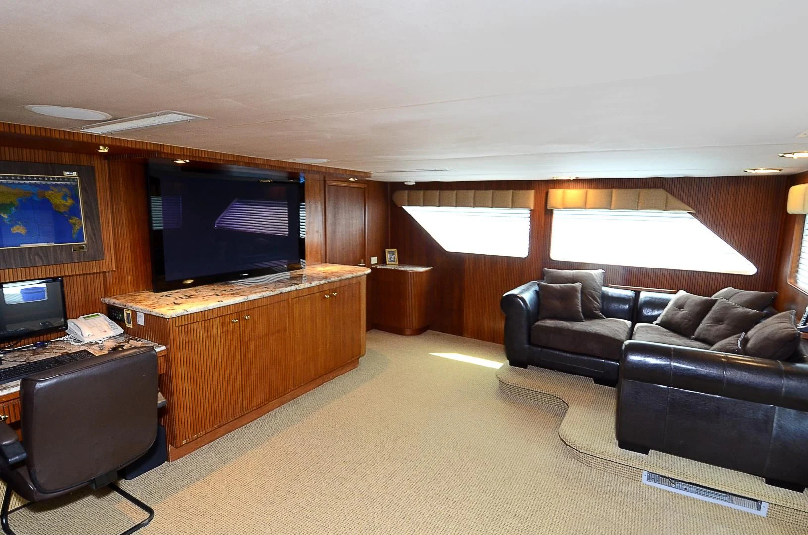 a living room with a couch and a tv aboard SHENANDOAH Yacht for Sale