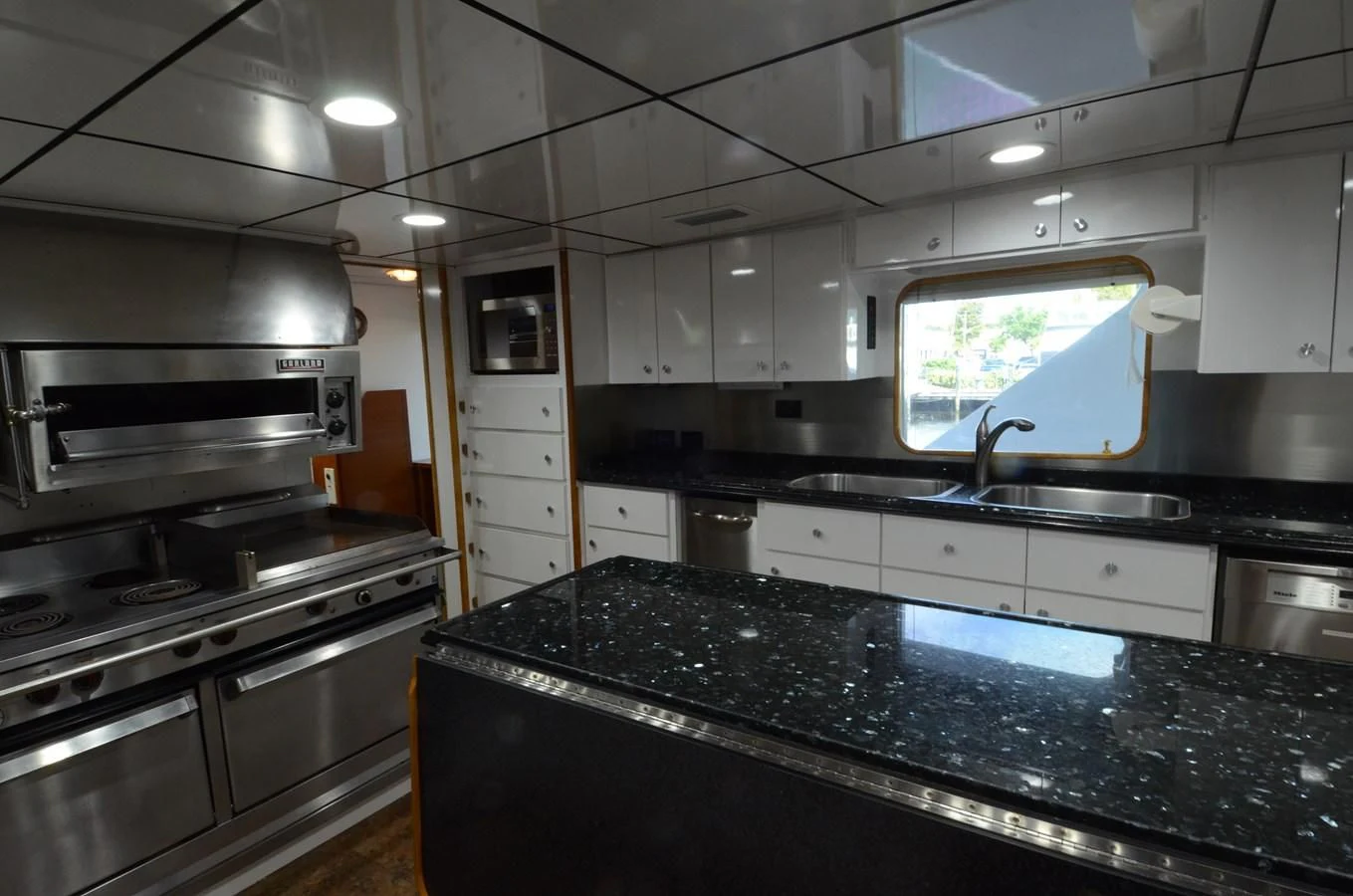 a kitchen with white cabinets aboard SHENANDOAH Yacht for Sale