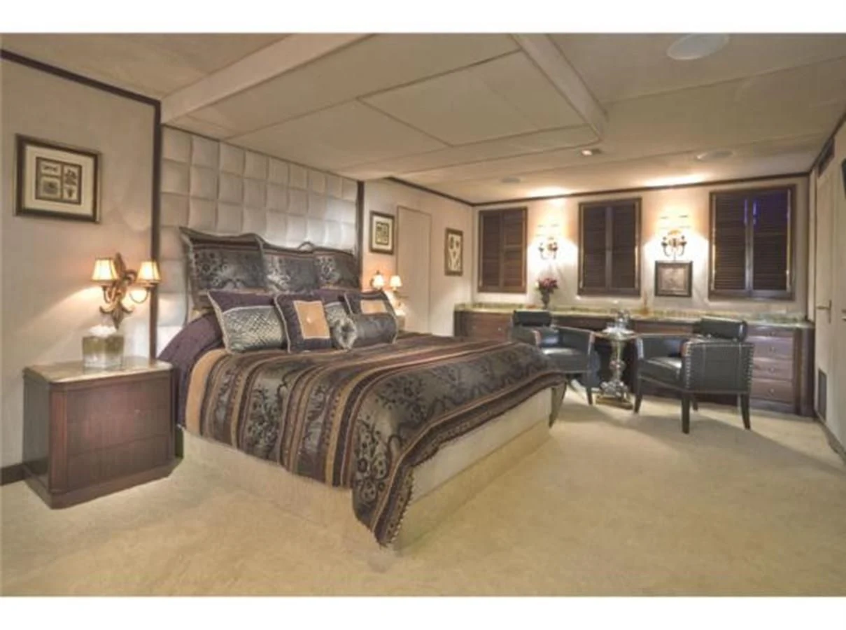 a large bedroom with a bed and a desk aboard SHENANDOAH Yacht for Sale