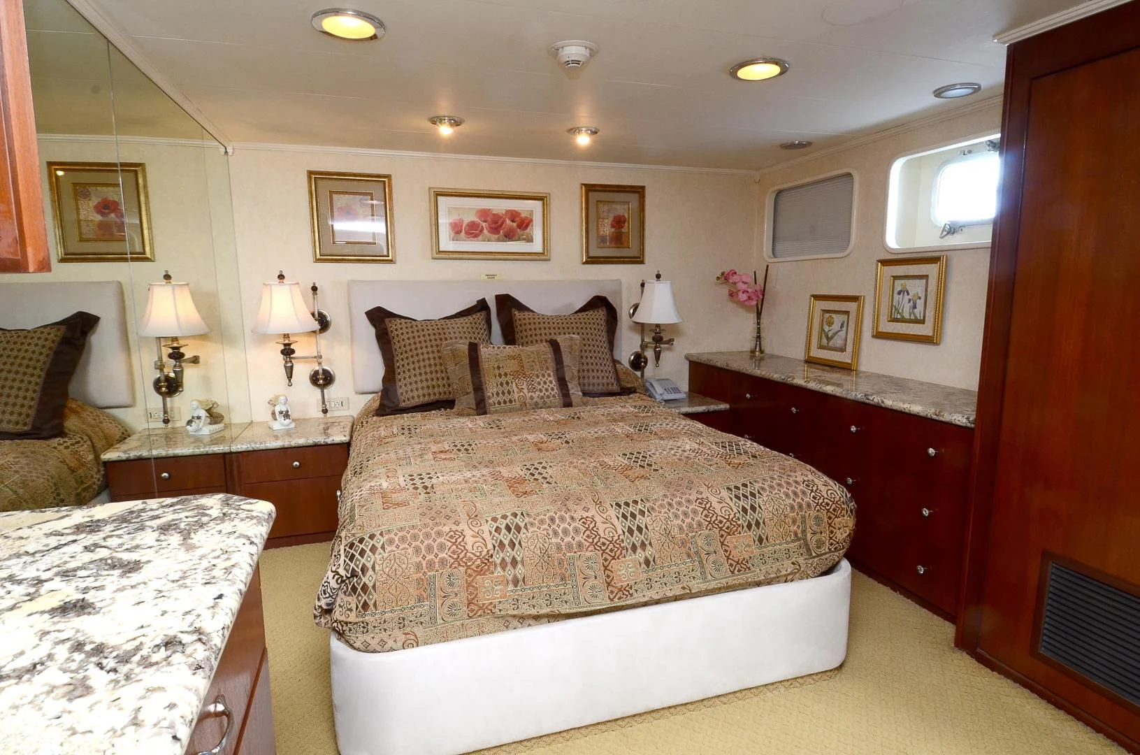 a bedroom with a bed and a lamp aboard SHENANDOAH Yacht for Sale