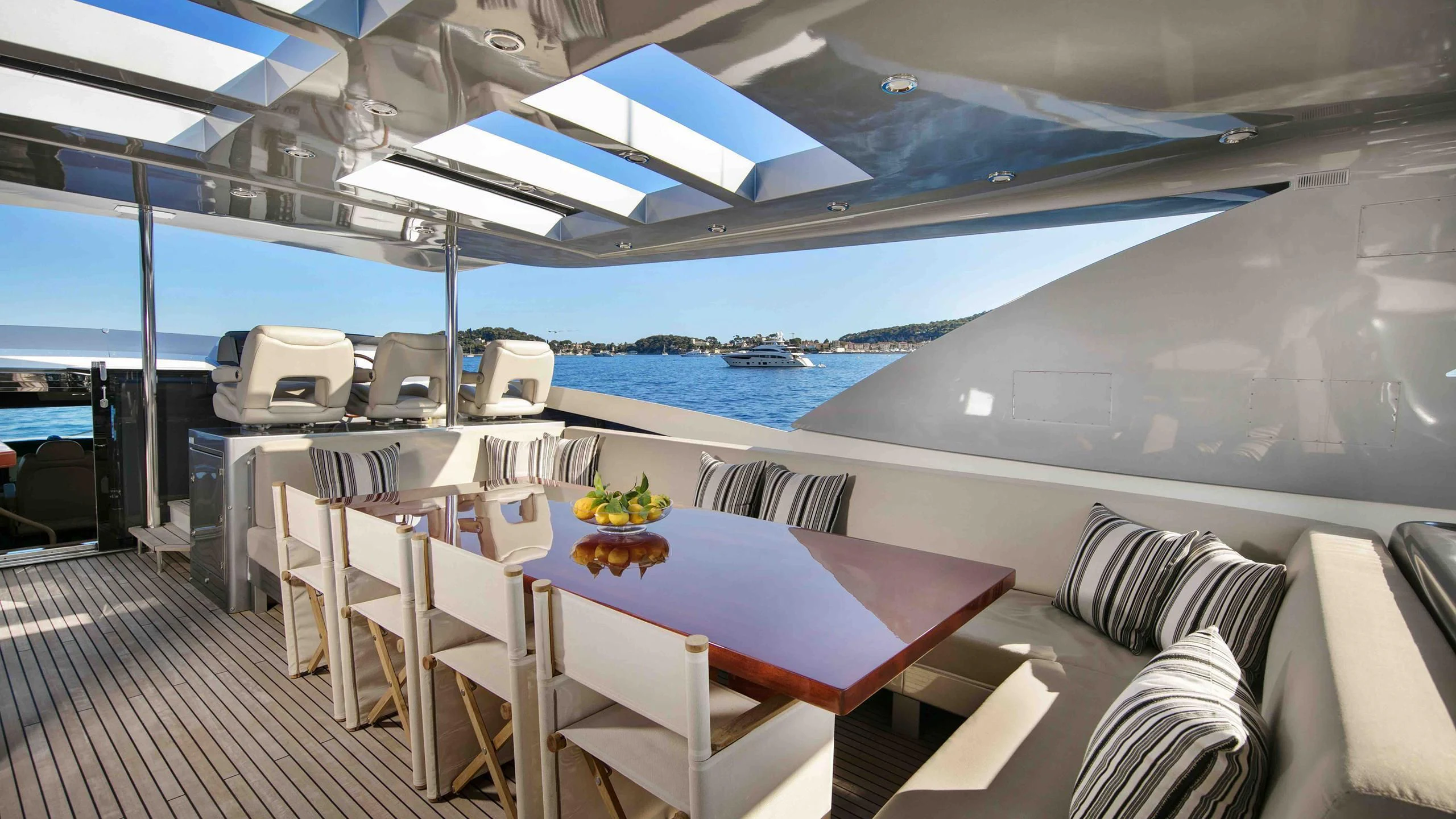a room with a table and chairs aboard APMONIA Yacht for Sale