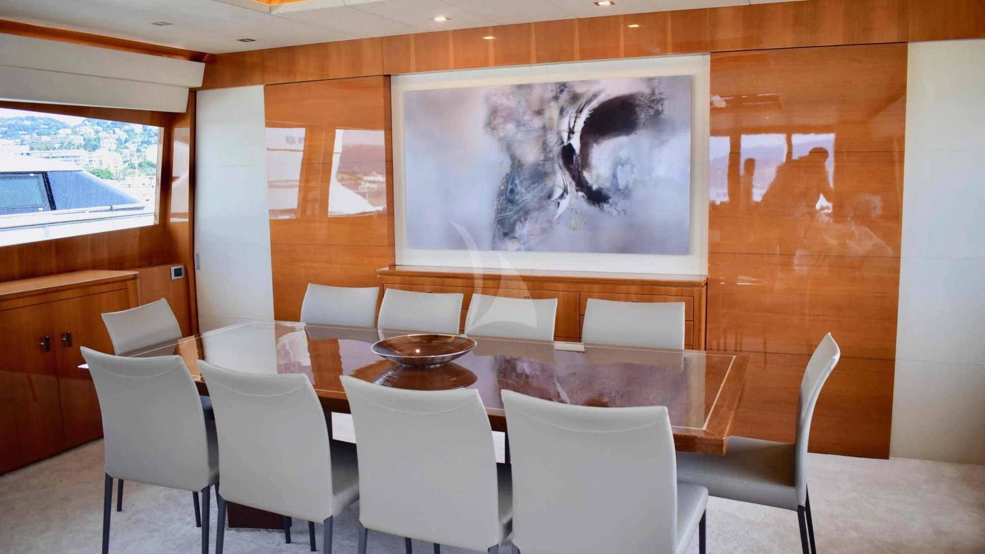 a table with chairs and a painting aboard APMONIA Yacht for Sale