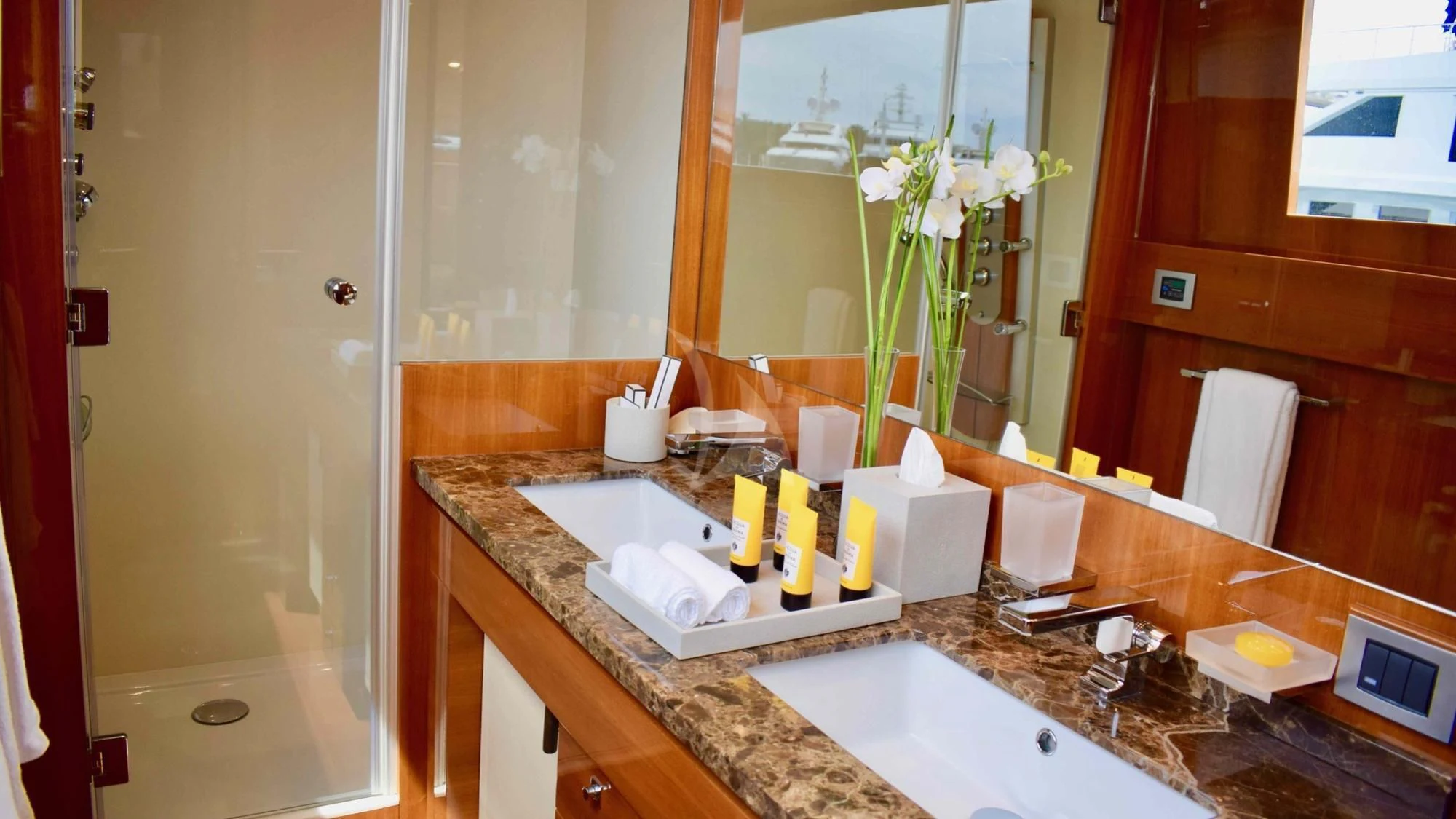 a bathroom with a countertop sink and a mirror aboard APMONIA Yacht for Sale