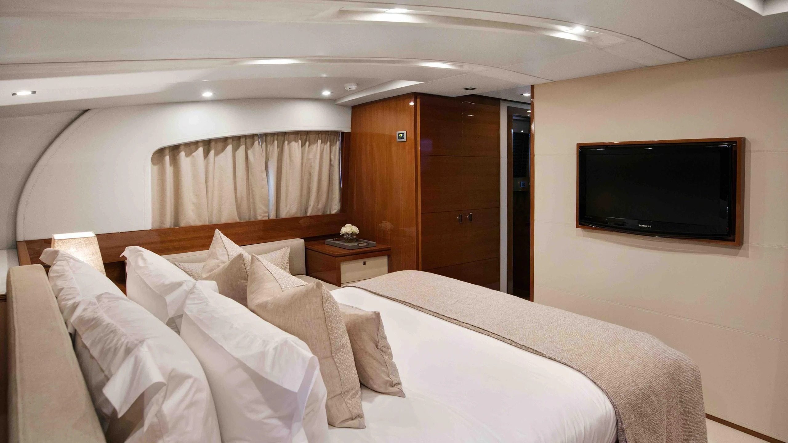 a hotel room with a bed and tv aboard APMONIA Yacht for Sale