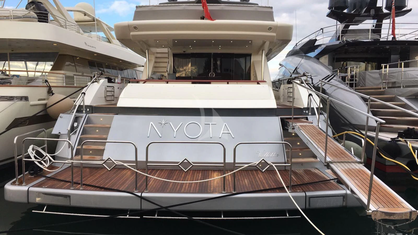 a boat docked at a pier aboard APMONIA Yacht for Sale