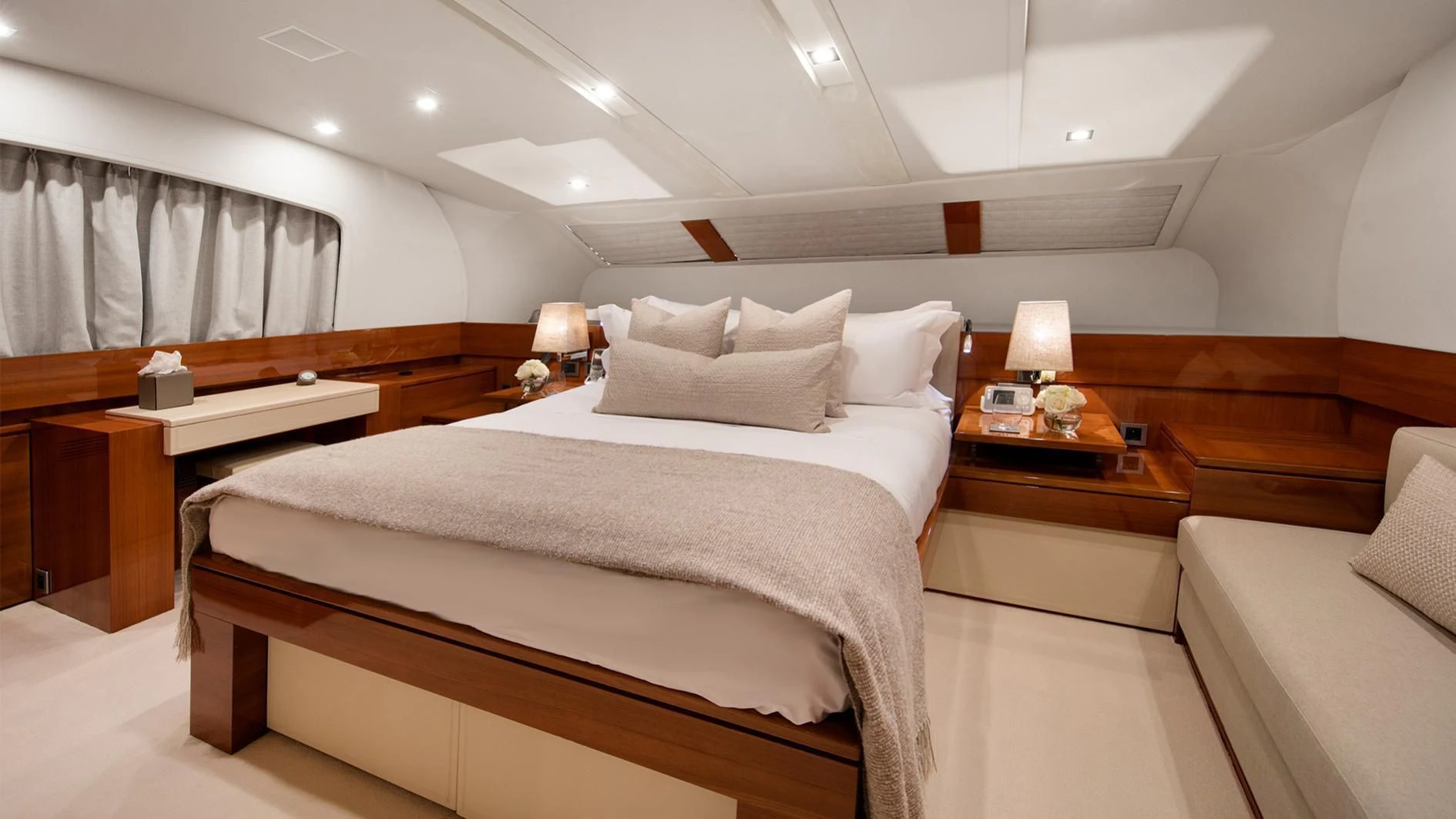 a room with a bed and a desk aboard APMONIA Yacht for Sale