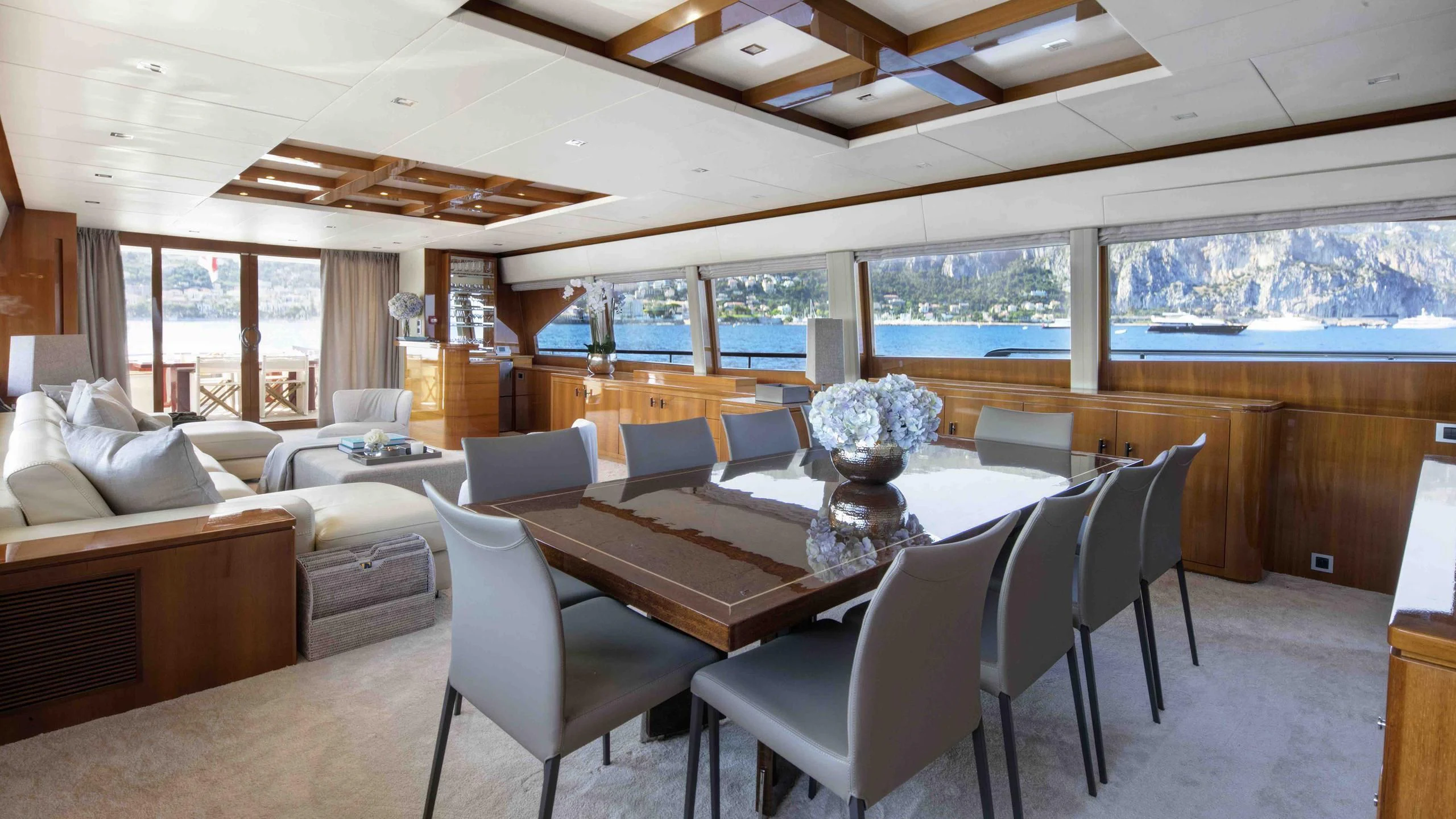 a large room with a table and chairs aboard APMONIA Yacht for Sale