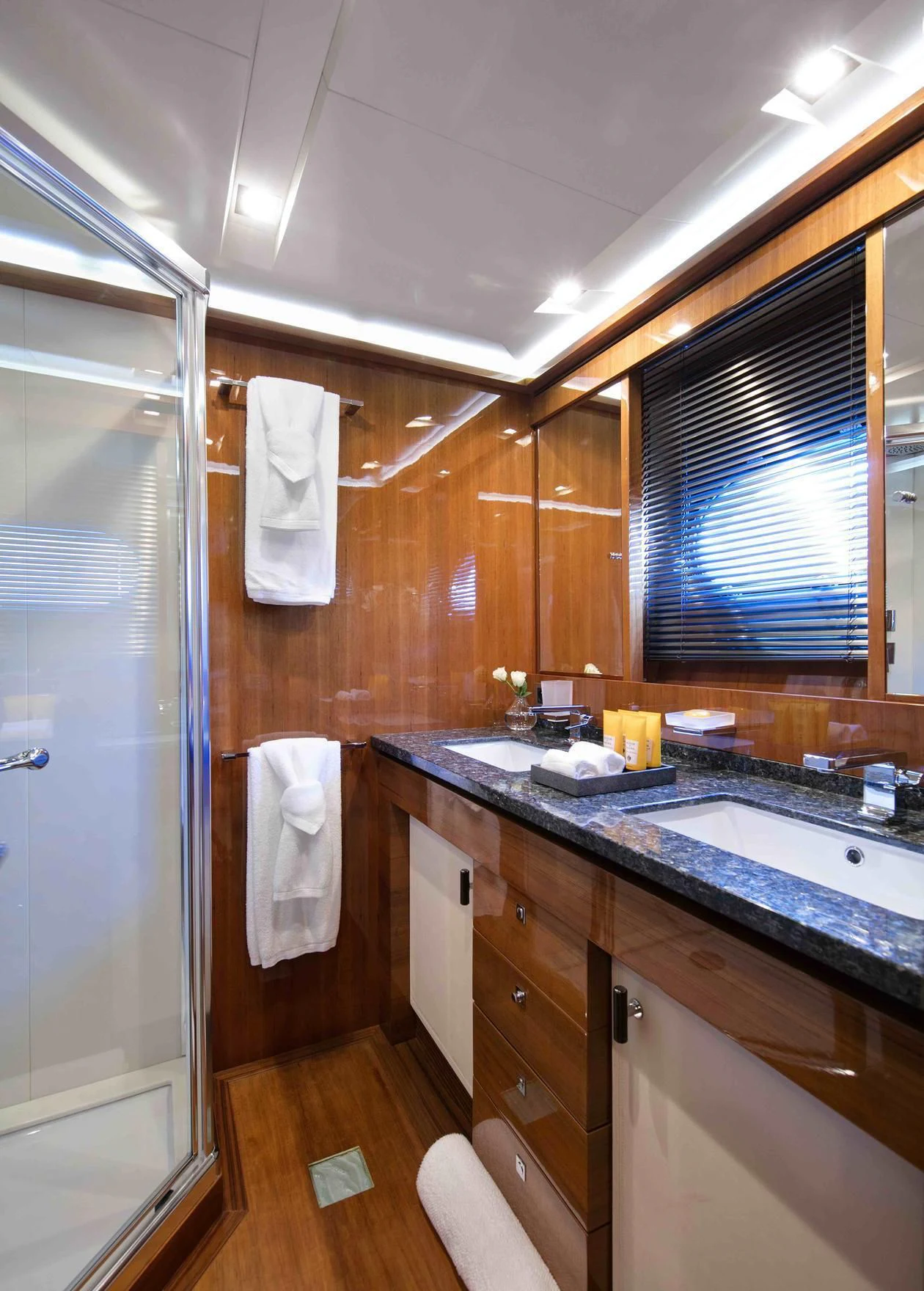a bathroom with wooden cabinets aboard APMONIA Yacht for Sale