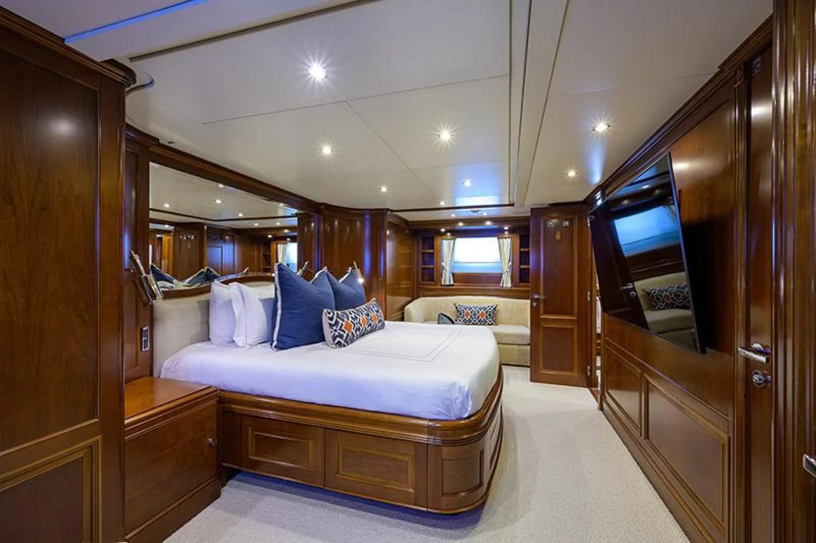 a bedroom with a bed and a mirror aboard ARTEMIS Yacht for Sale
