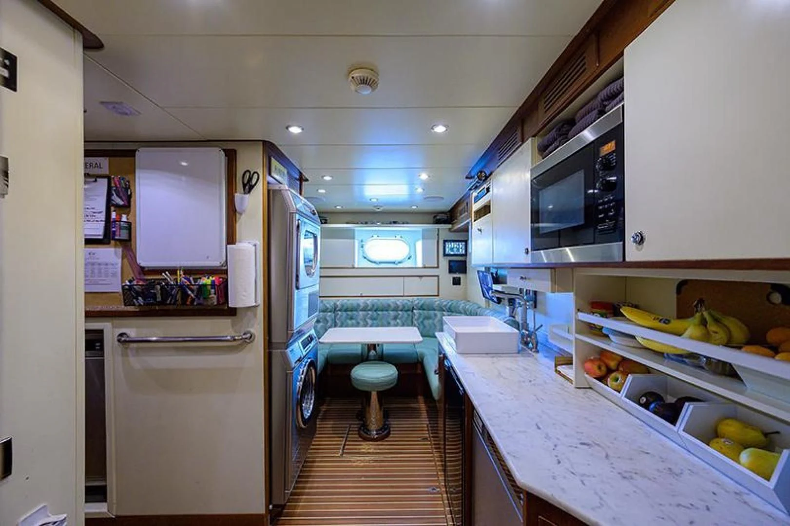 a kitchen with a table and chairs aboard ARTEMIS Yacht for Sale