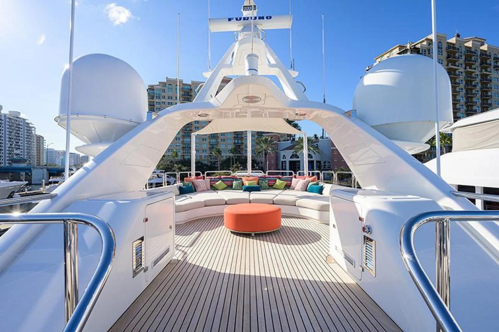 a walkway with a railing and a large building in the background aboard ARTEMIS Yacht for Sale