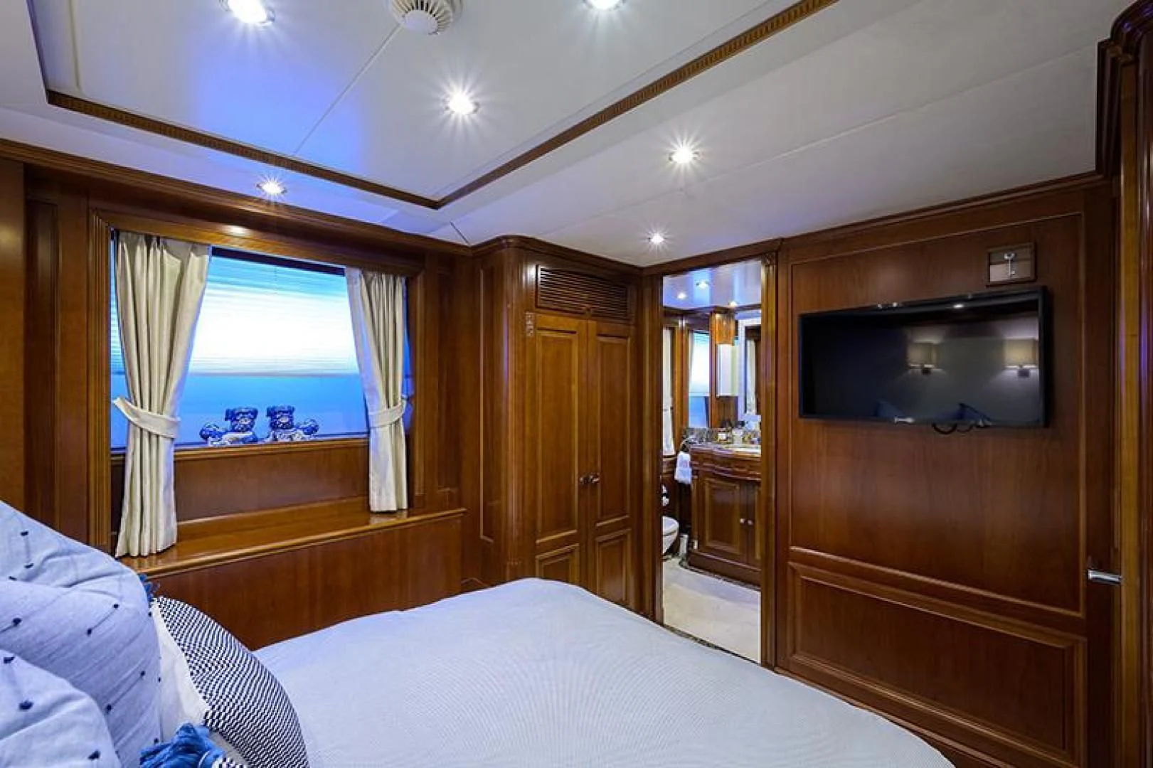 a bedroom with a tv and a bed aboard ARTEMIS Yacht for Sale