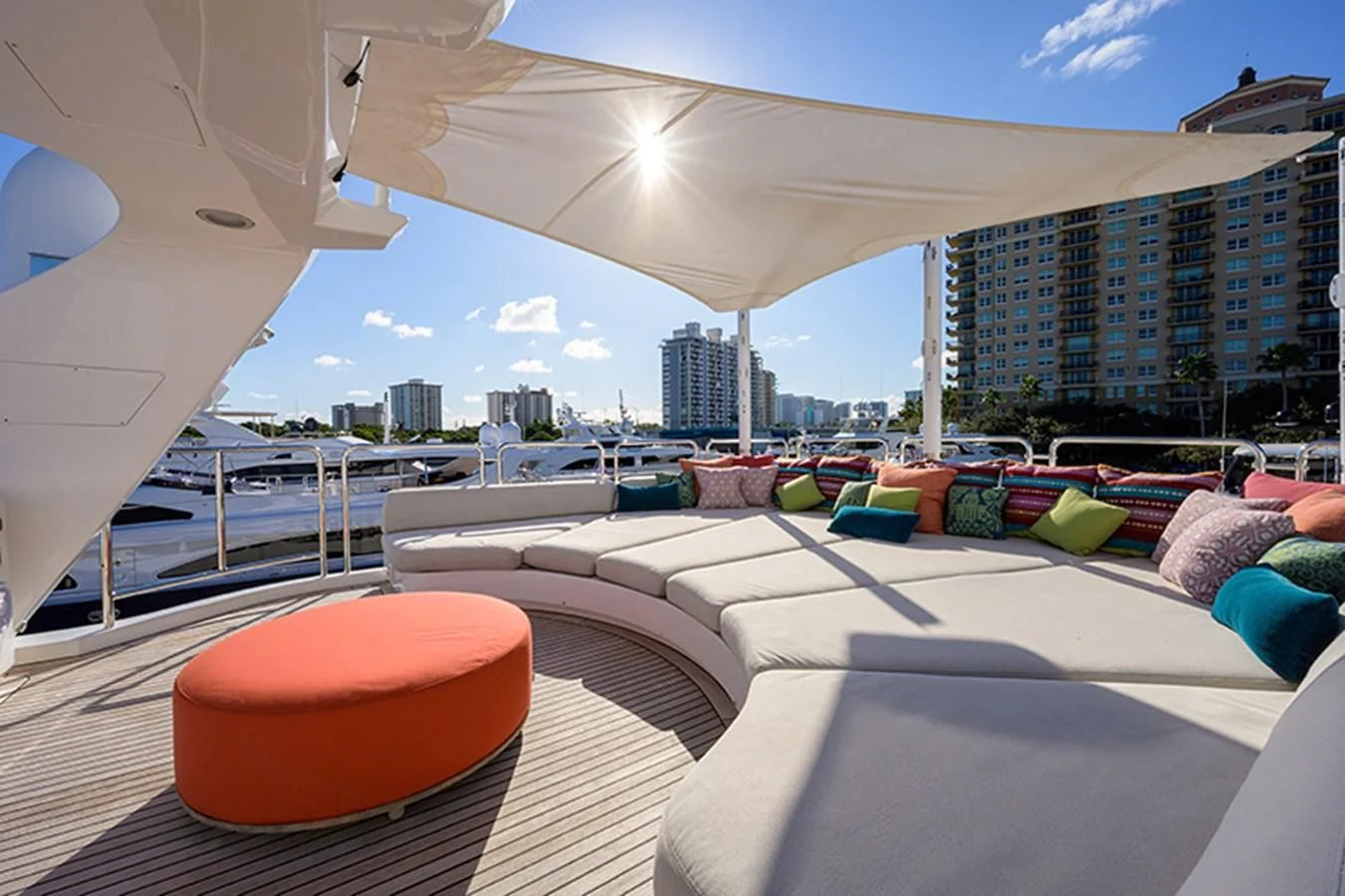 a room with a large bed and a city in the background aboard ARTEMIS Yacht for Sale