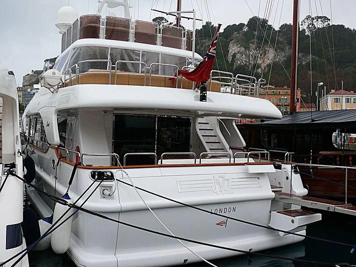 a white boat with red flags on it aboard ARTEMIS Yacht for Sale