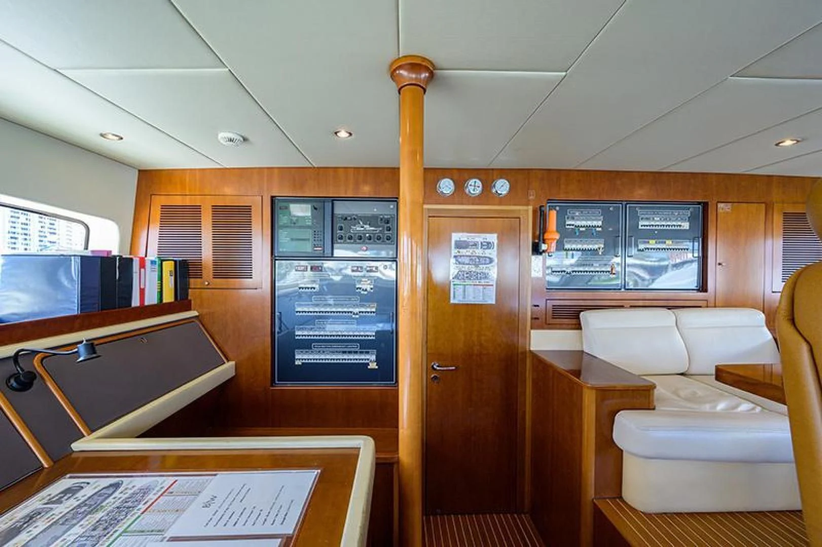 a room with a couch and a tv on the wall aboard ARTEMIS Yacht for Sale