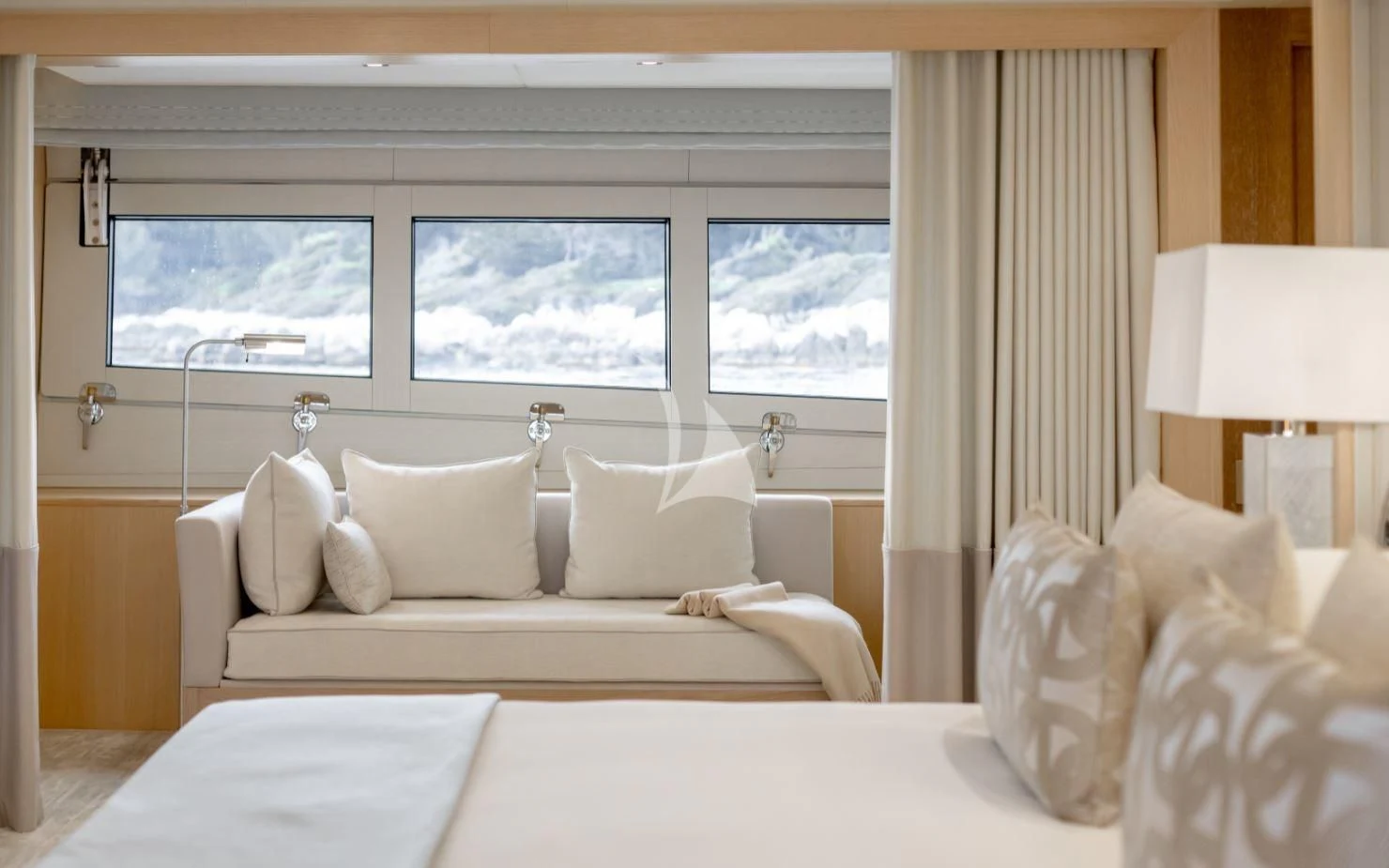 a bed with white sheets and pillows aboard ARADOS Yacht for Charter