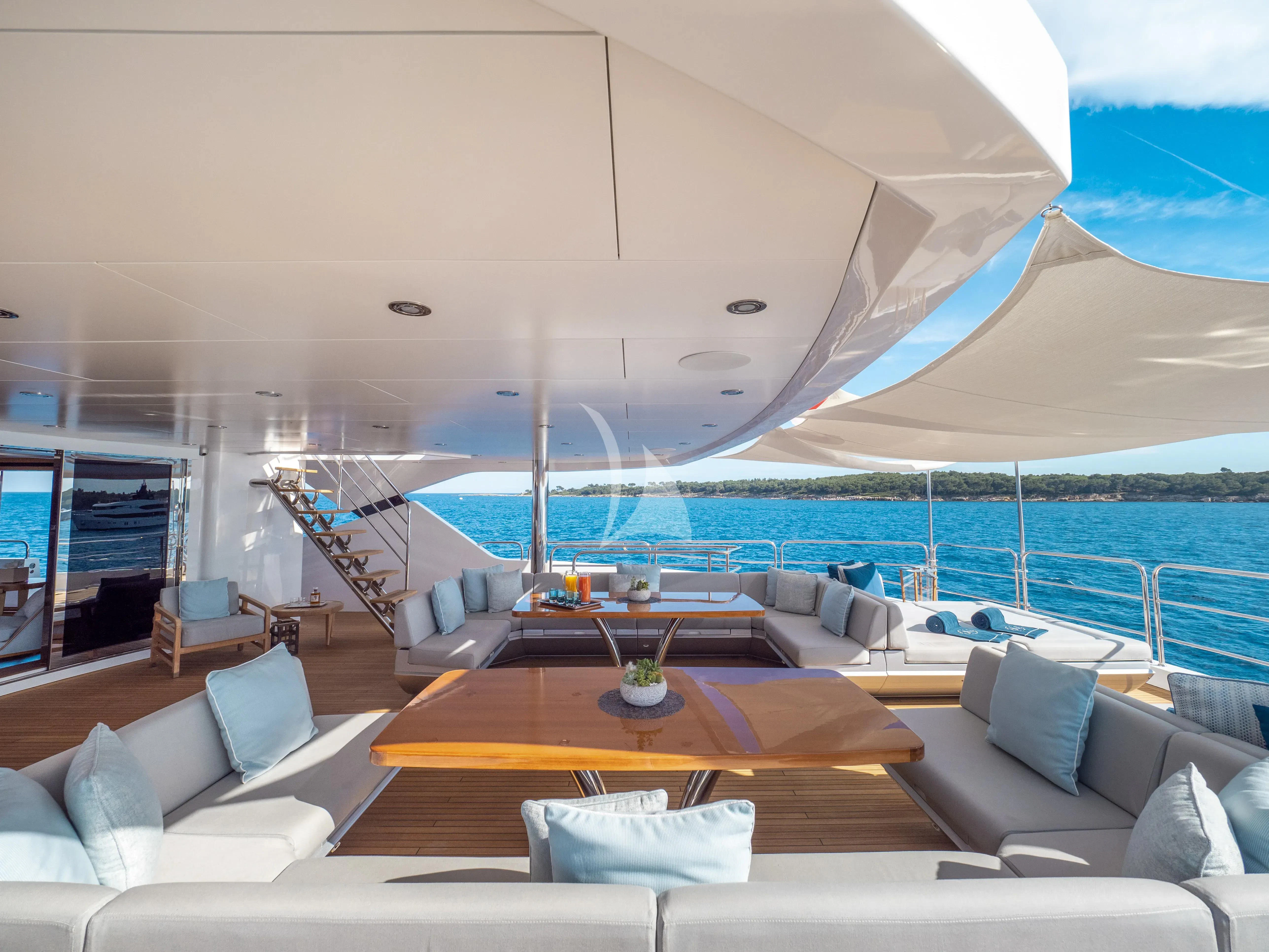 a large living room with a large swimming pool aboard ARADOS Yacht for Charter