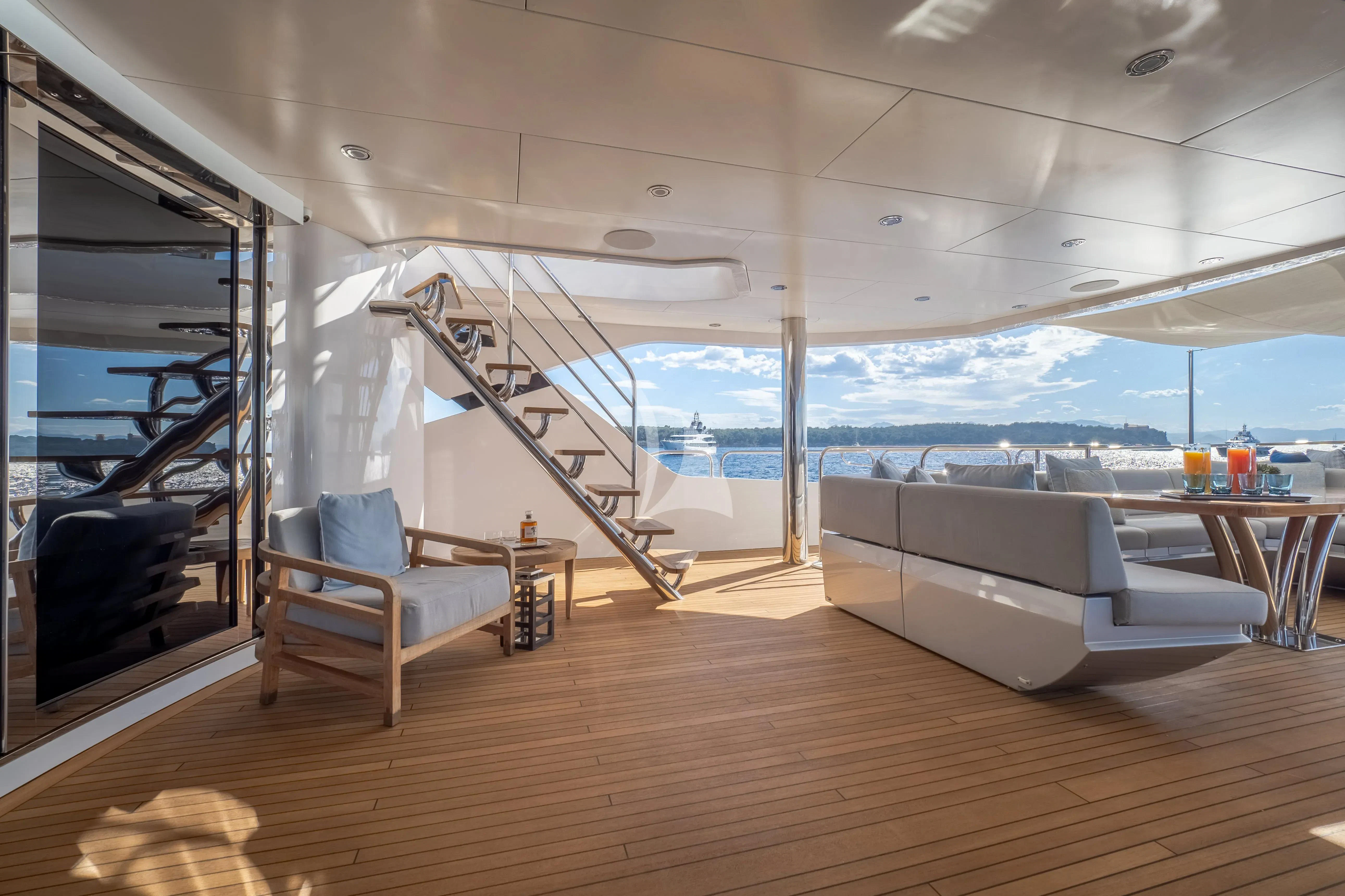 a room with a large window and a wood floor aboard ARADOS Yacht for Charter