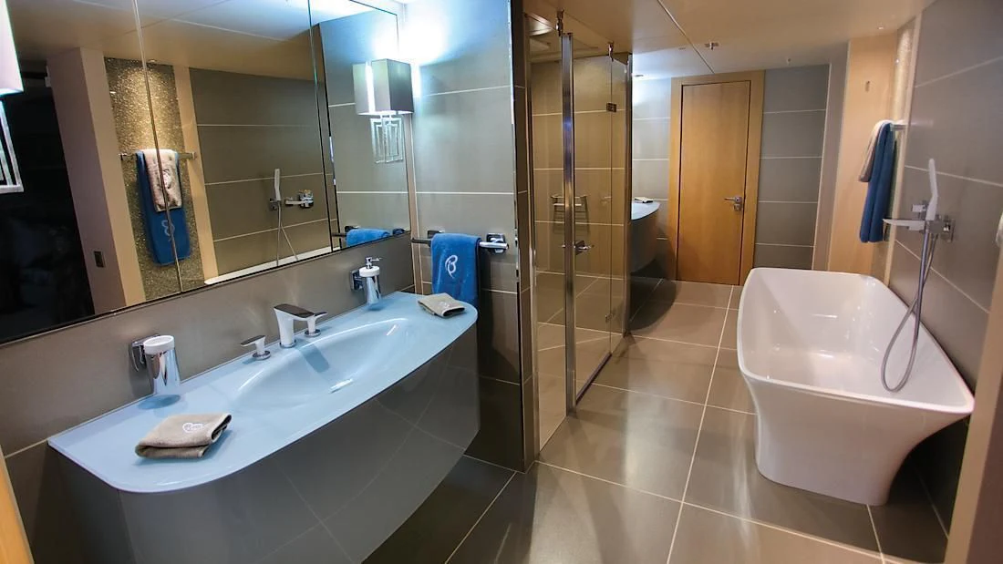 a bathroom with a bathtub sink and a shower aboard ARADOS Yacht for Charter