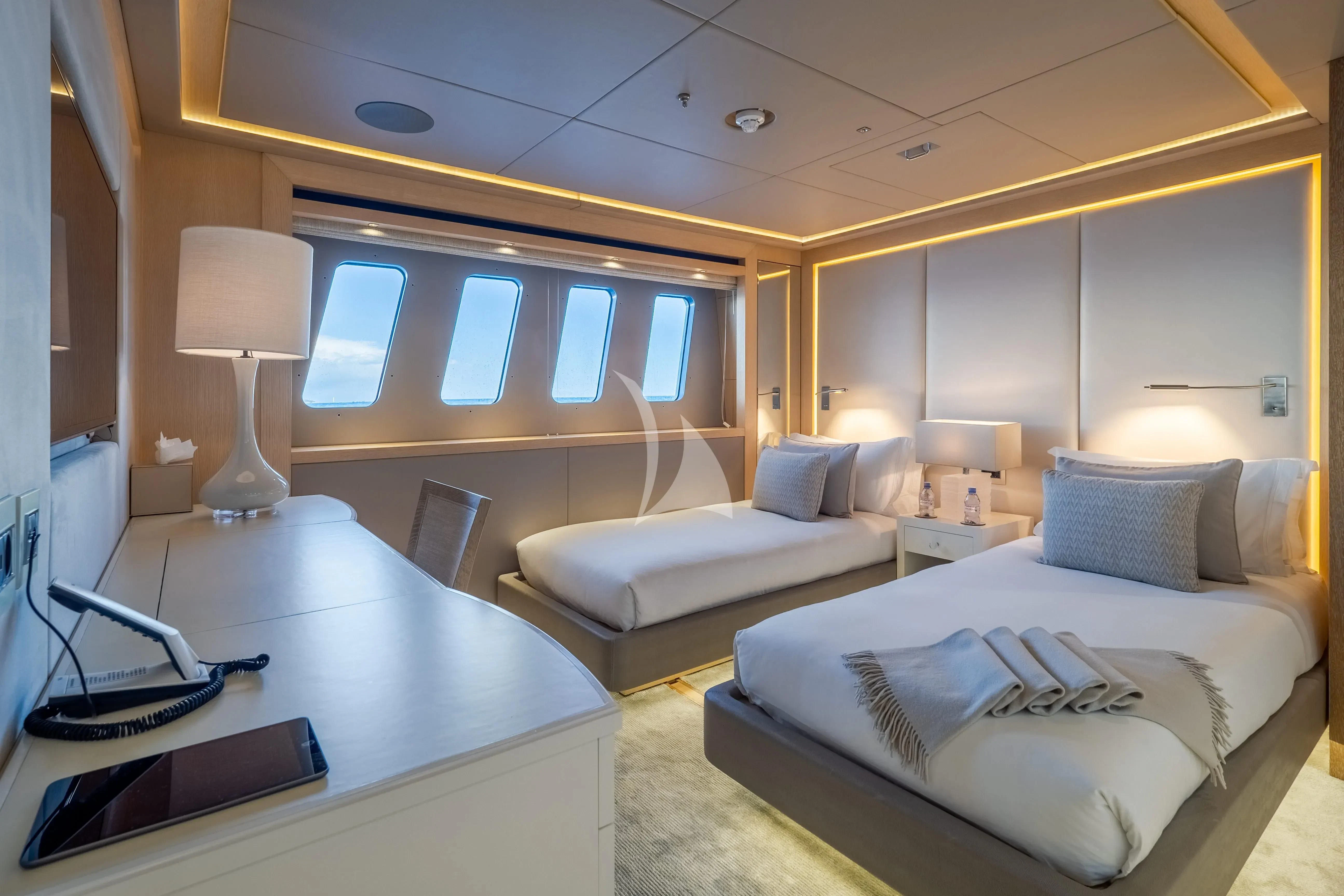 a room with a bed and a desk aboard ARADOS Yacht for Charter