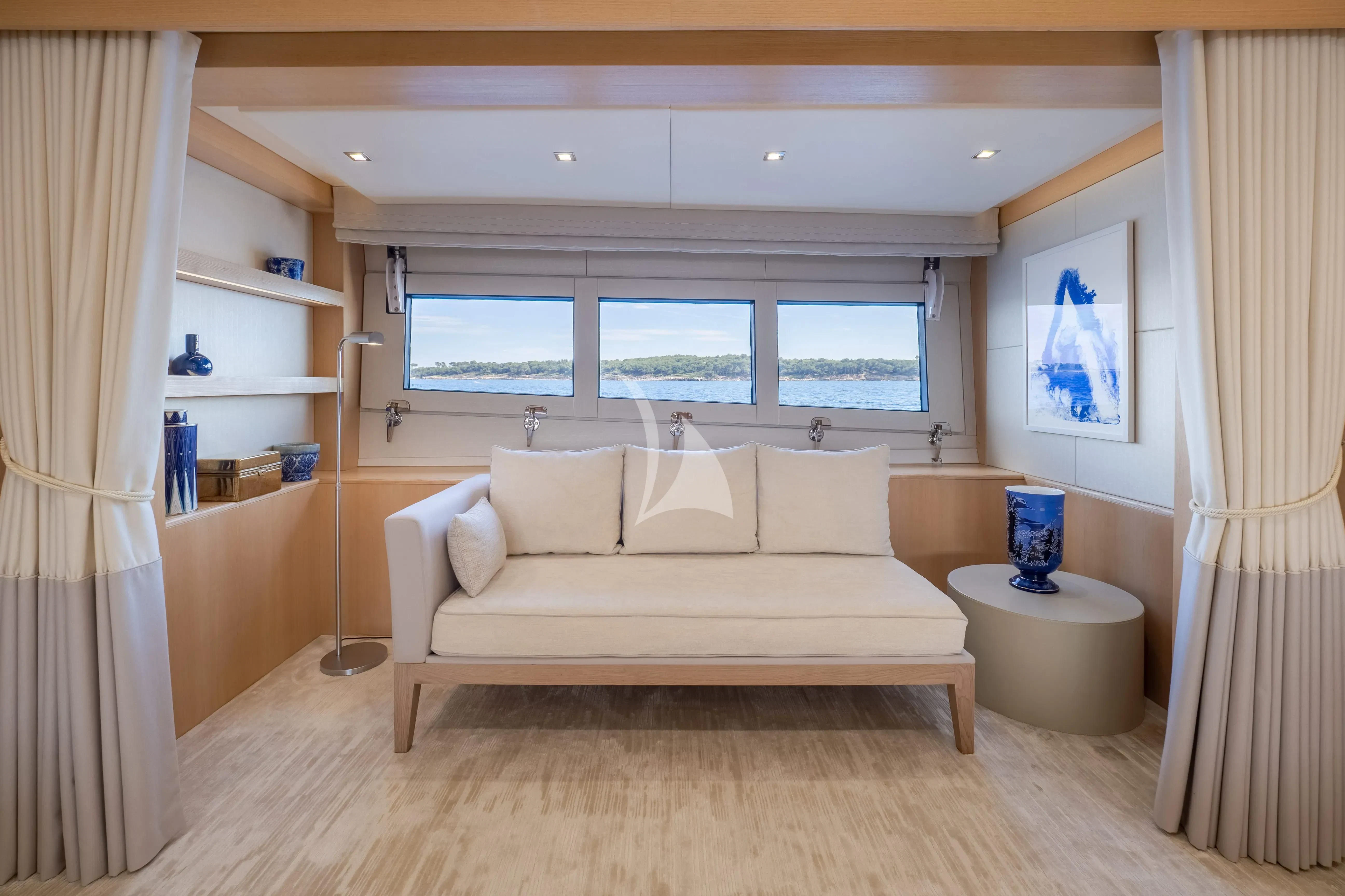 a room with a bed and a shelf with a window aboard ARADOS Yacht for Charter