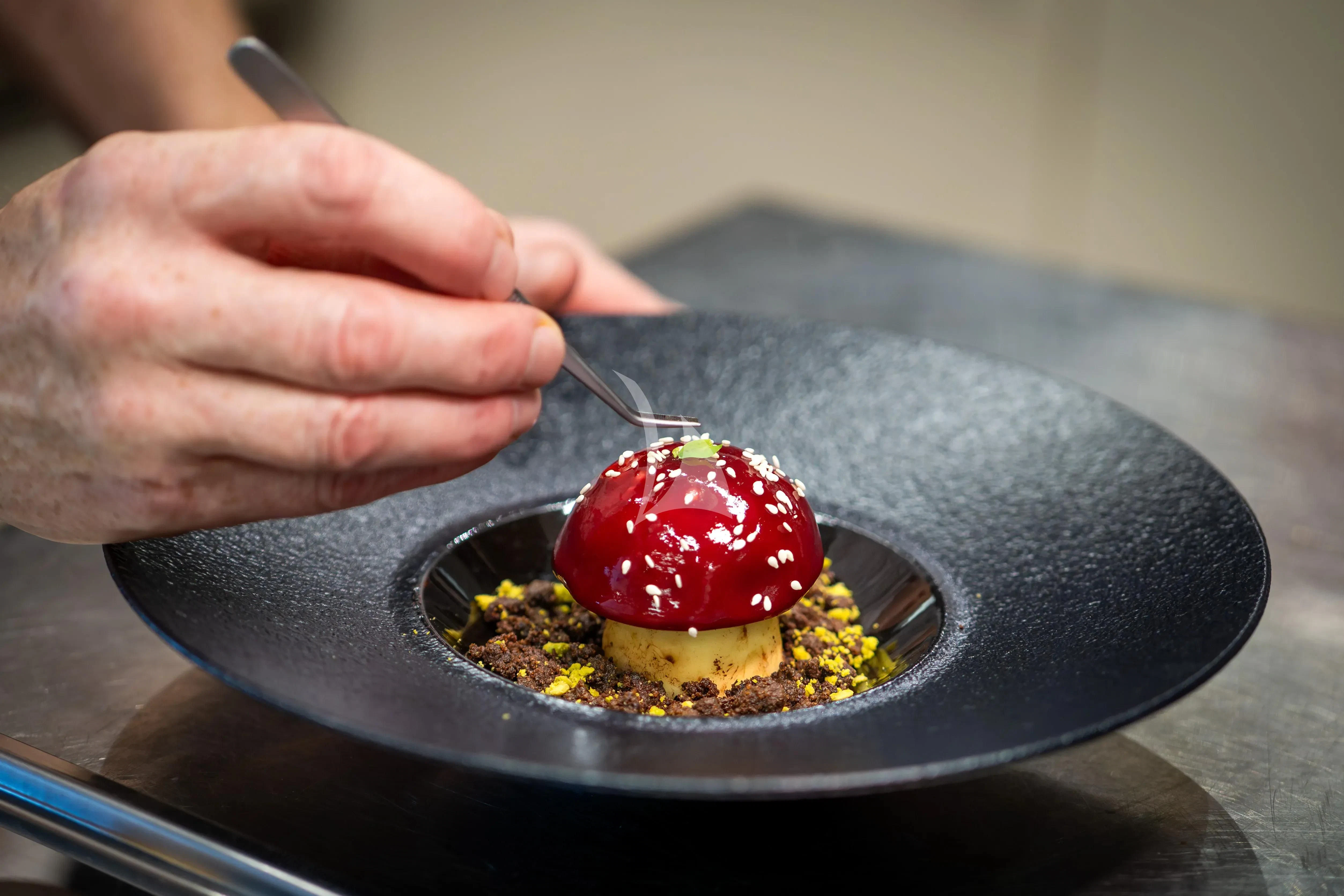 a person holding a spoon over a bowl of food aboard ARADOS Yacht for Charter