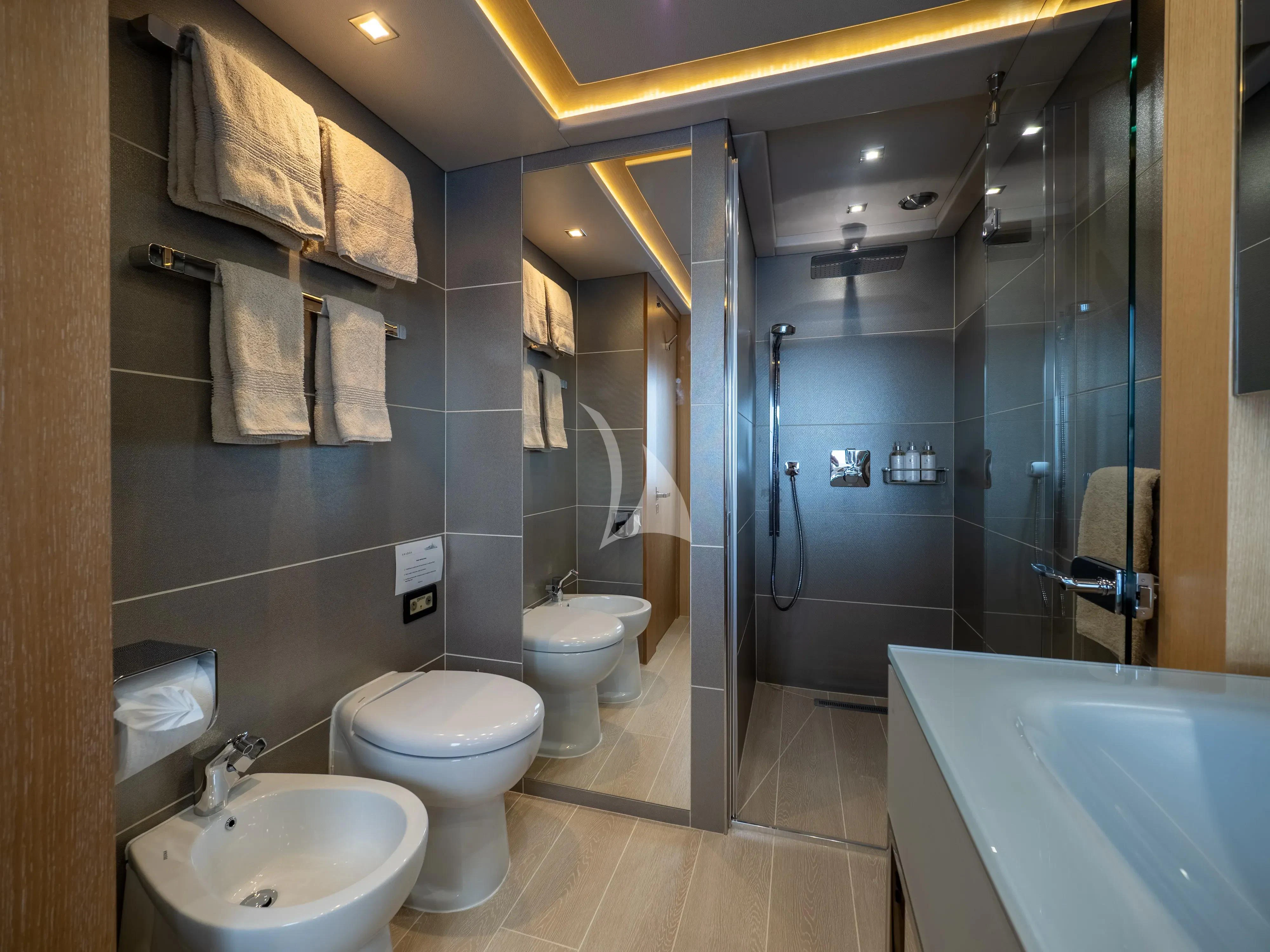 a bathroom with a glass shower aboard ARADOS Yacht for Charter