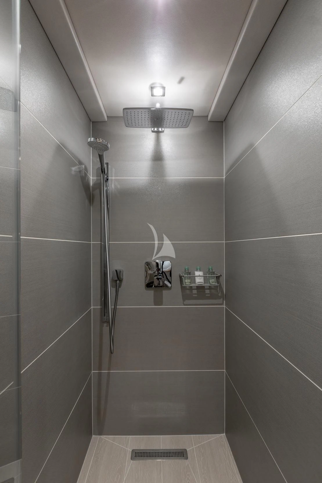 a shower with a sink and a mirror aboard ARADOS Yacht for Charter