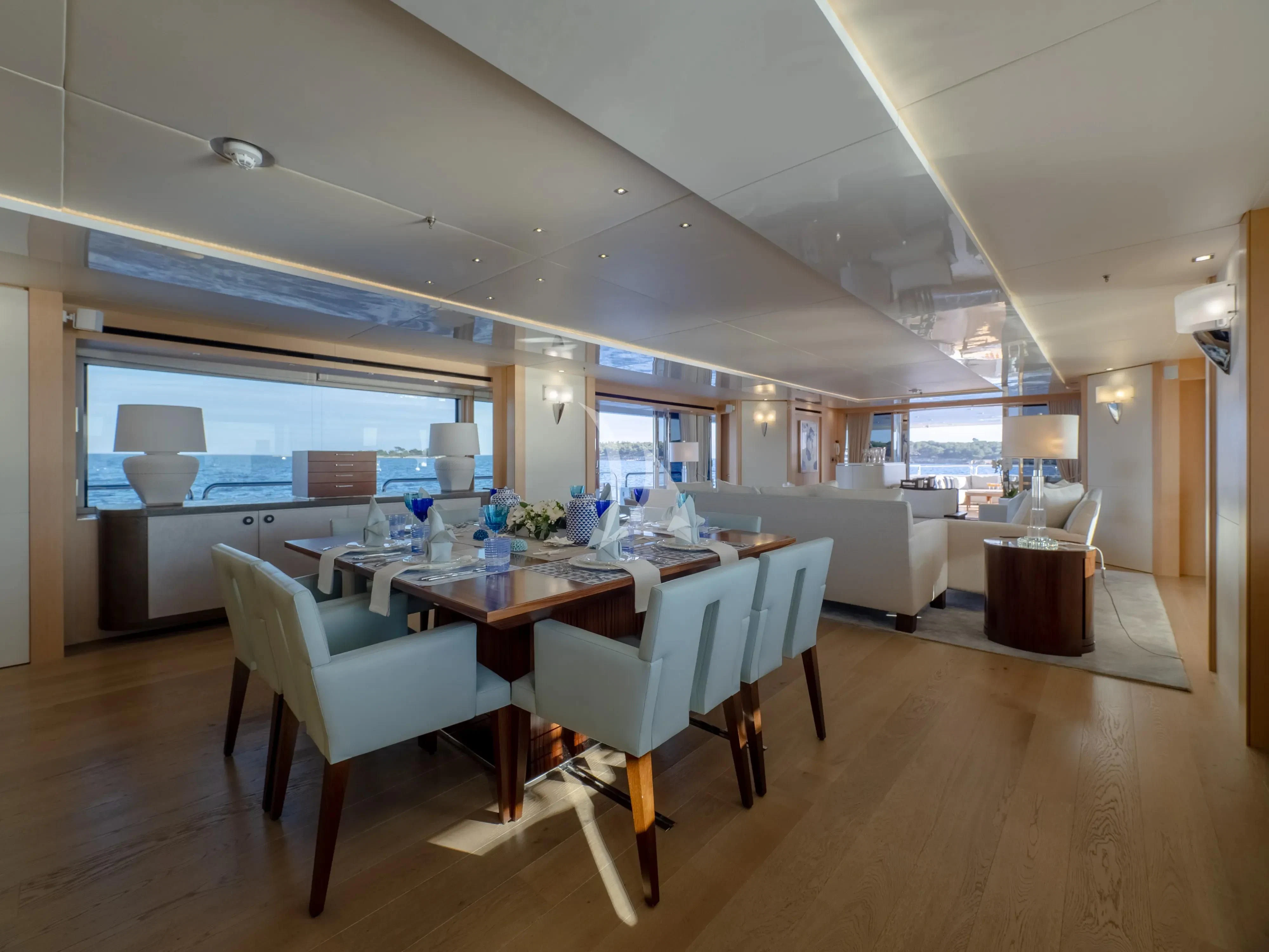 a large room with a table and chairs aboard ARADOS Yacht for Charter