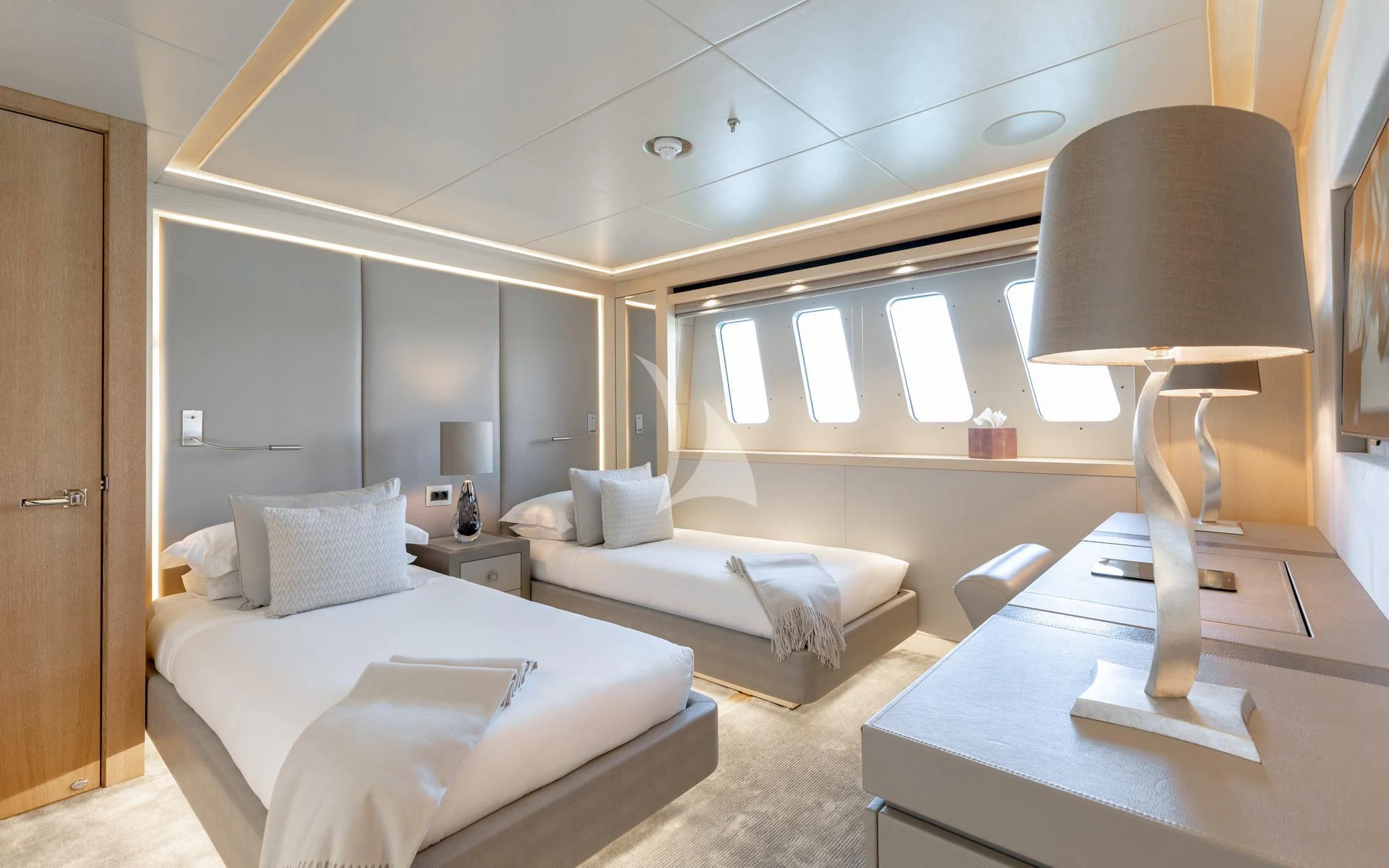 a room with a bed and a lamp aboard ARADOS Yacht for Charter