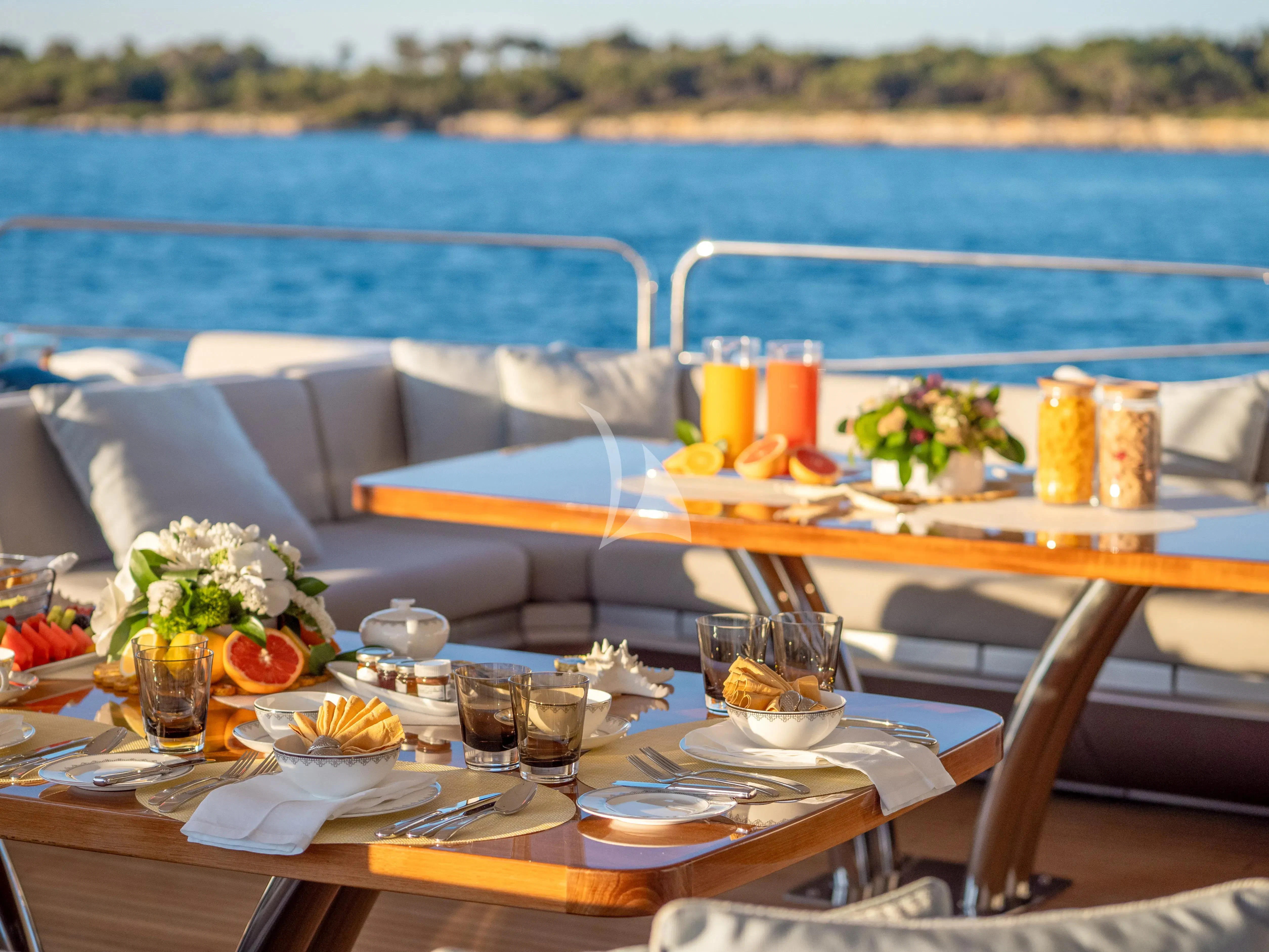 a table with food and drinks on it aboard ARADOS Yacht for Charter