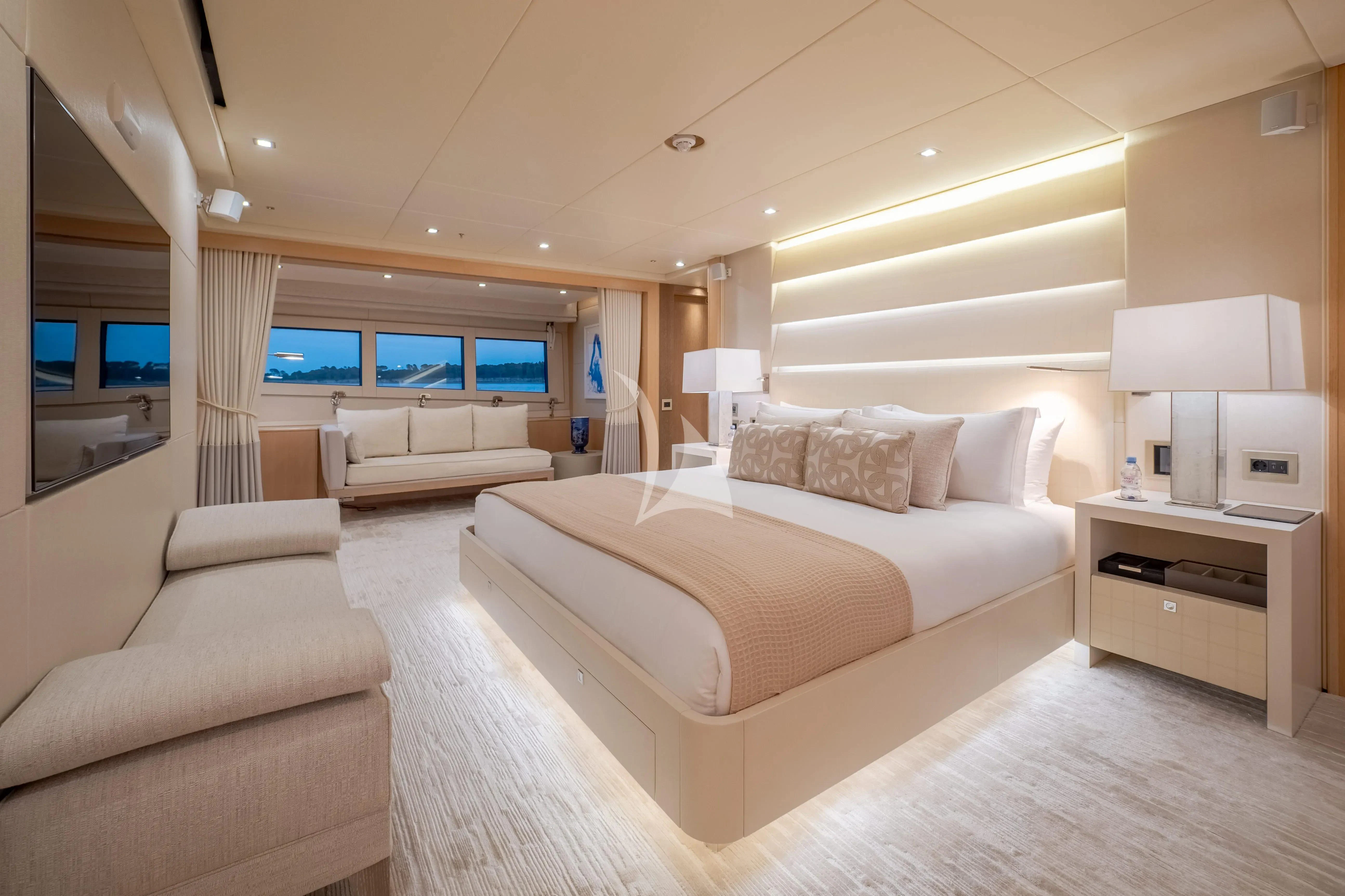 a large bedroom with a bed and a tv aboard ARADOS Yacht for Charter