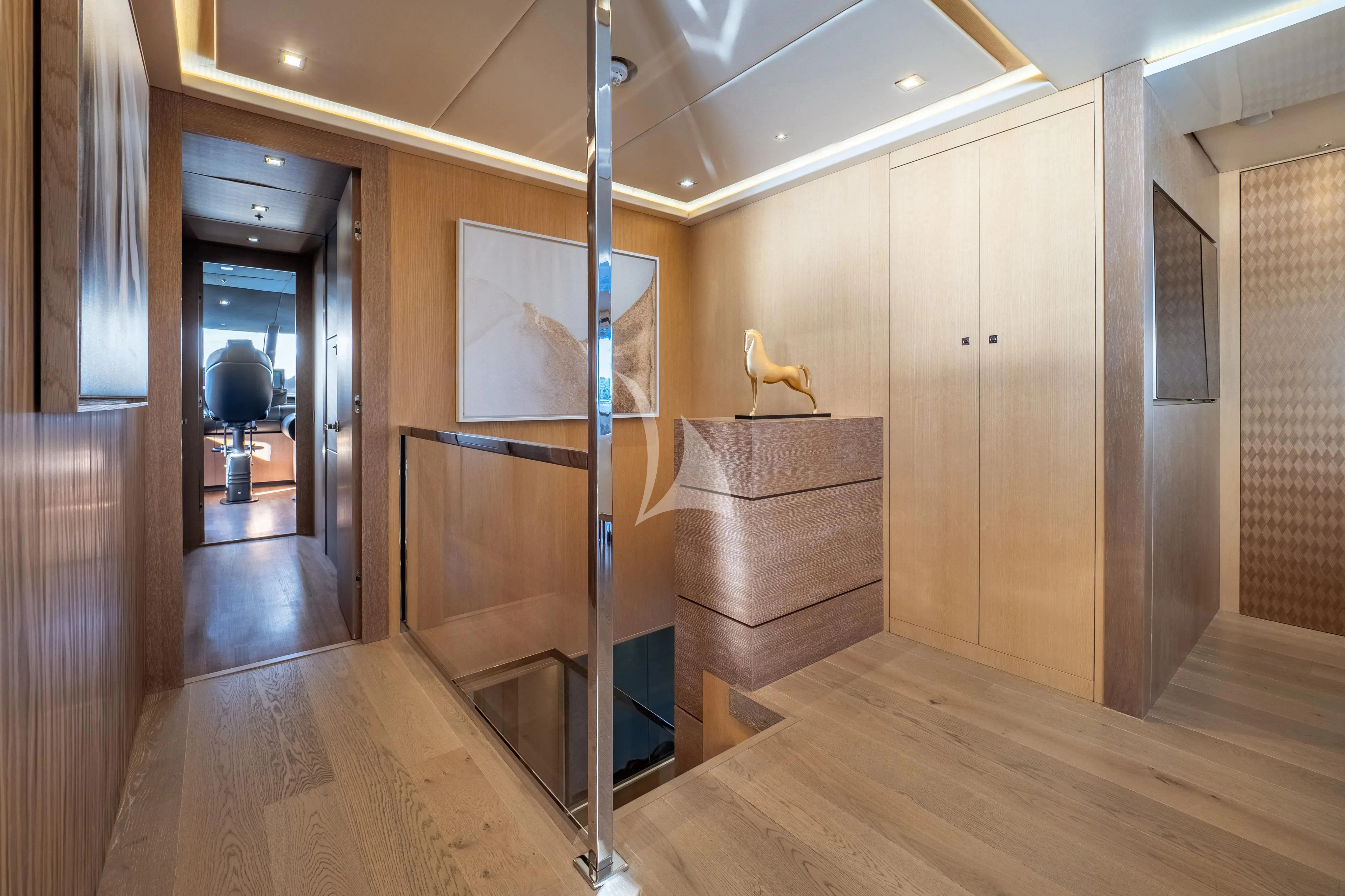 a room with a wood floor and a ladder aboard ARADOS Yacht for Charter