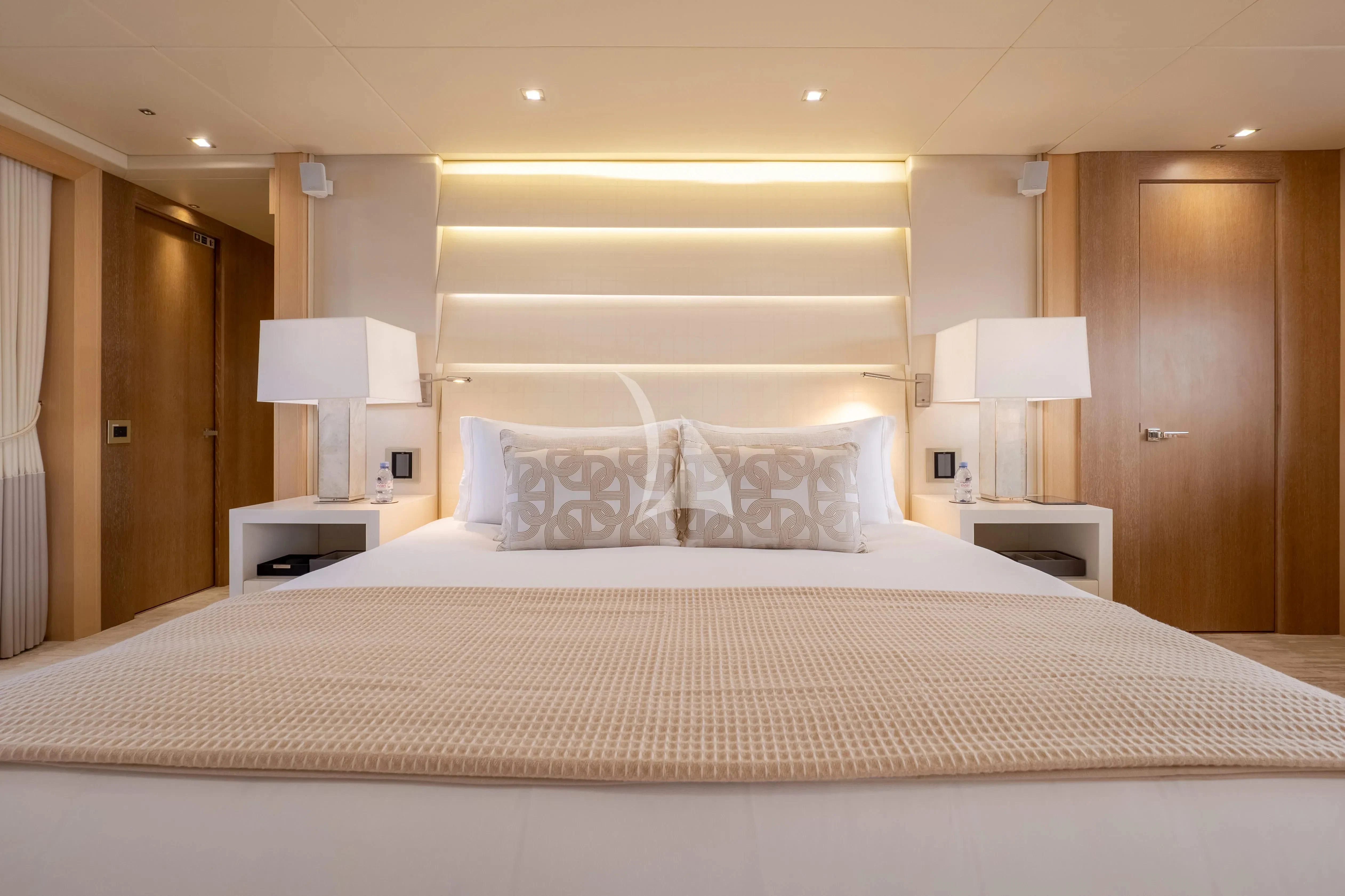 a large bed with white sheets aboard ARADOS Yacht for Charter