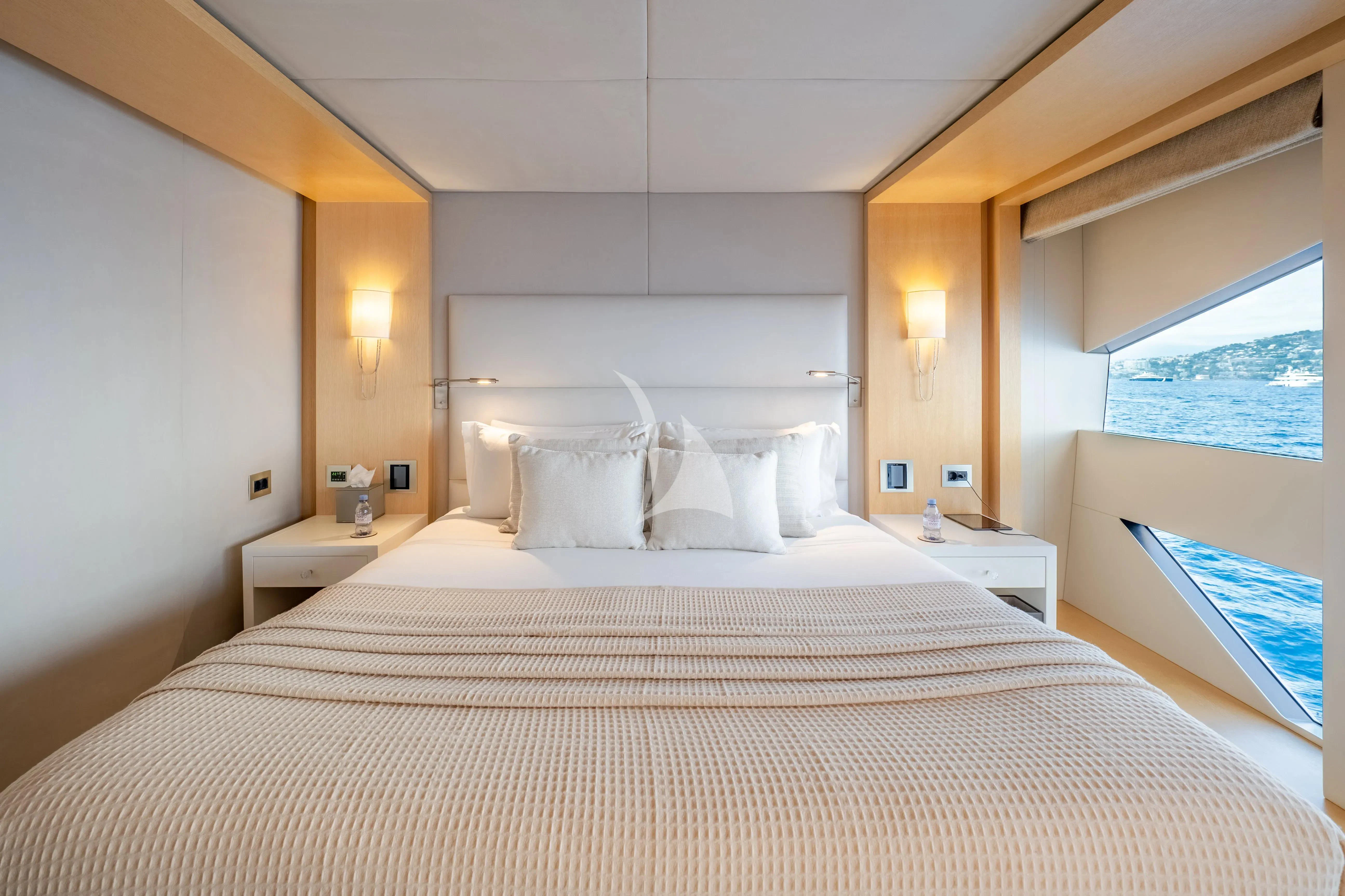 a bed with white sheets aboard ARADOS Yacht for Charter