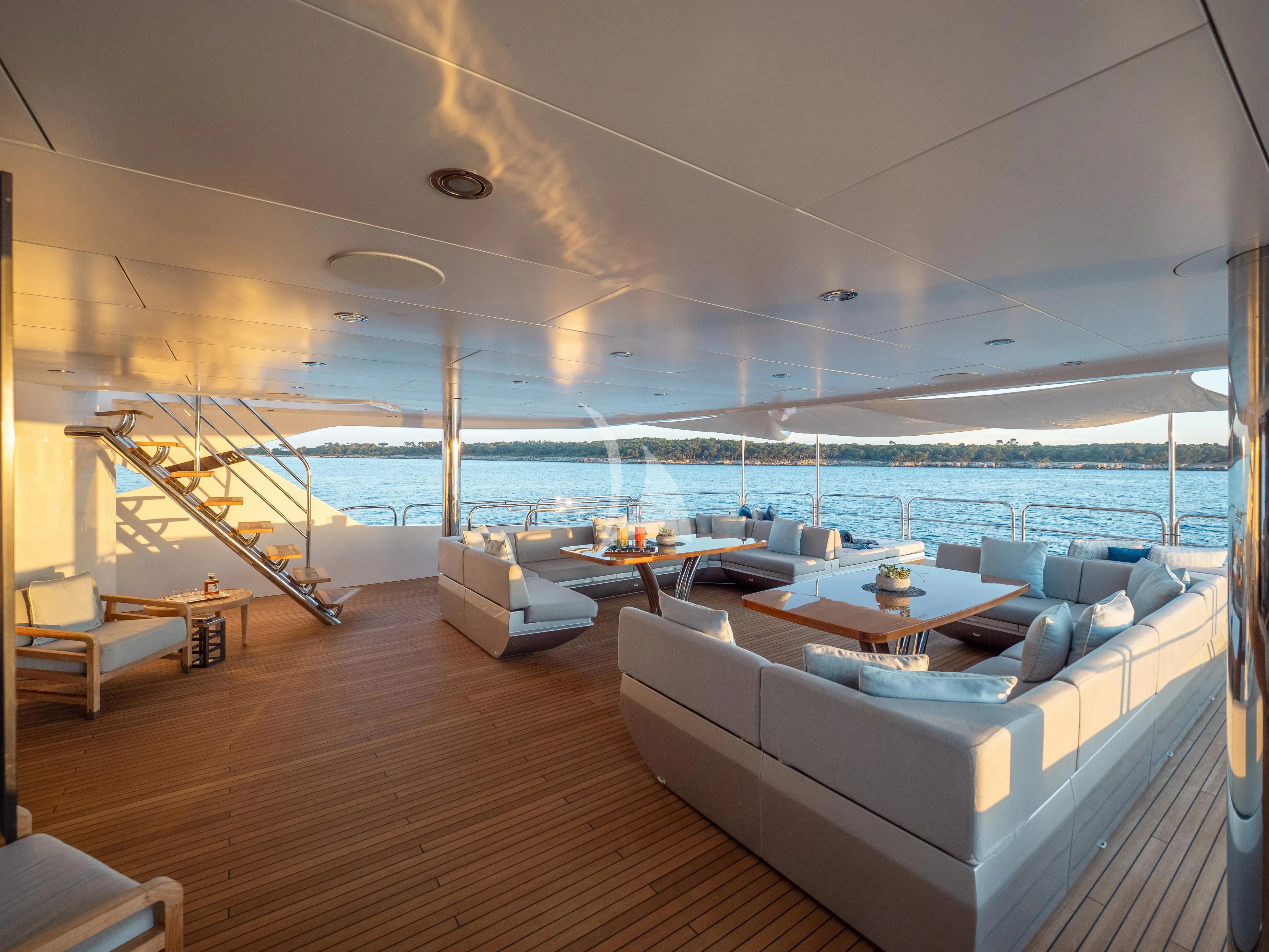 a living room with a large balcony aboard ARADOS Yacht for Charter