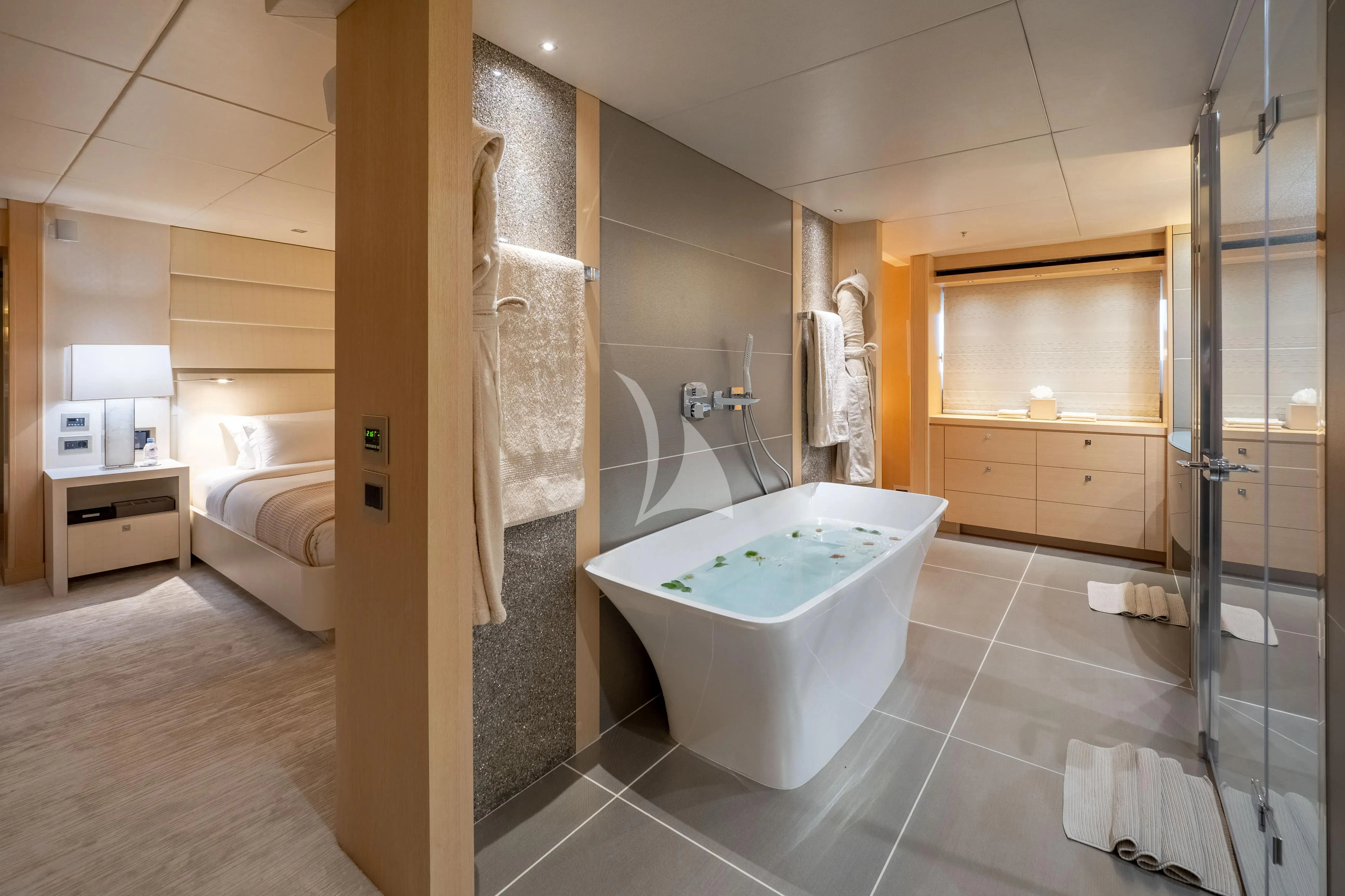 a bathroom with a bathtub and shower aboard ARADOS Yacht for Charter