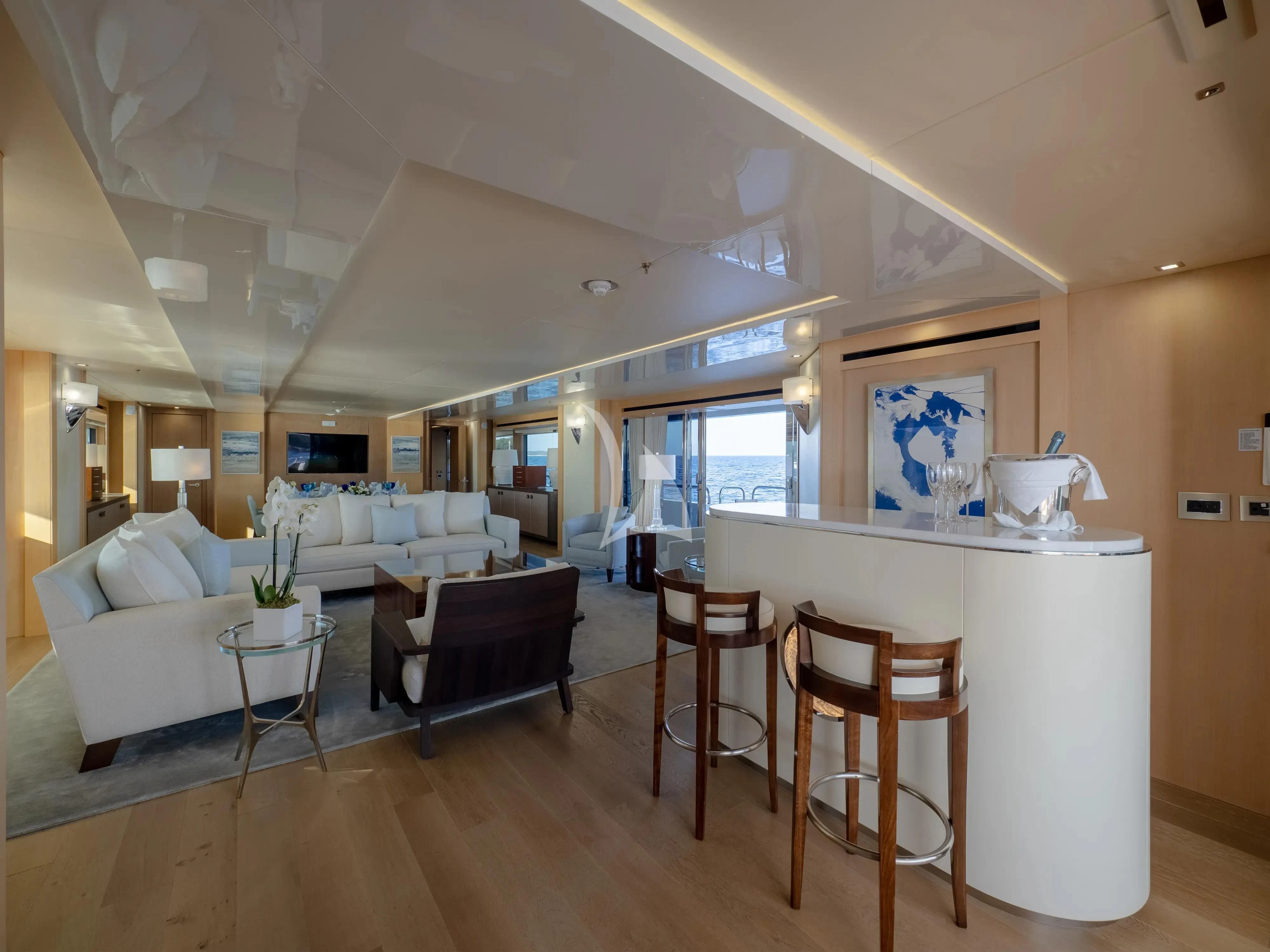 a living room with a kitchen and dining area aboard ARADOS Yacht for Charter