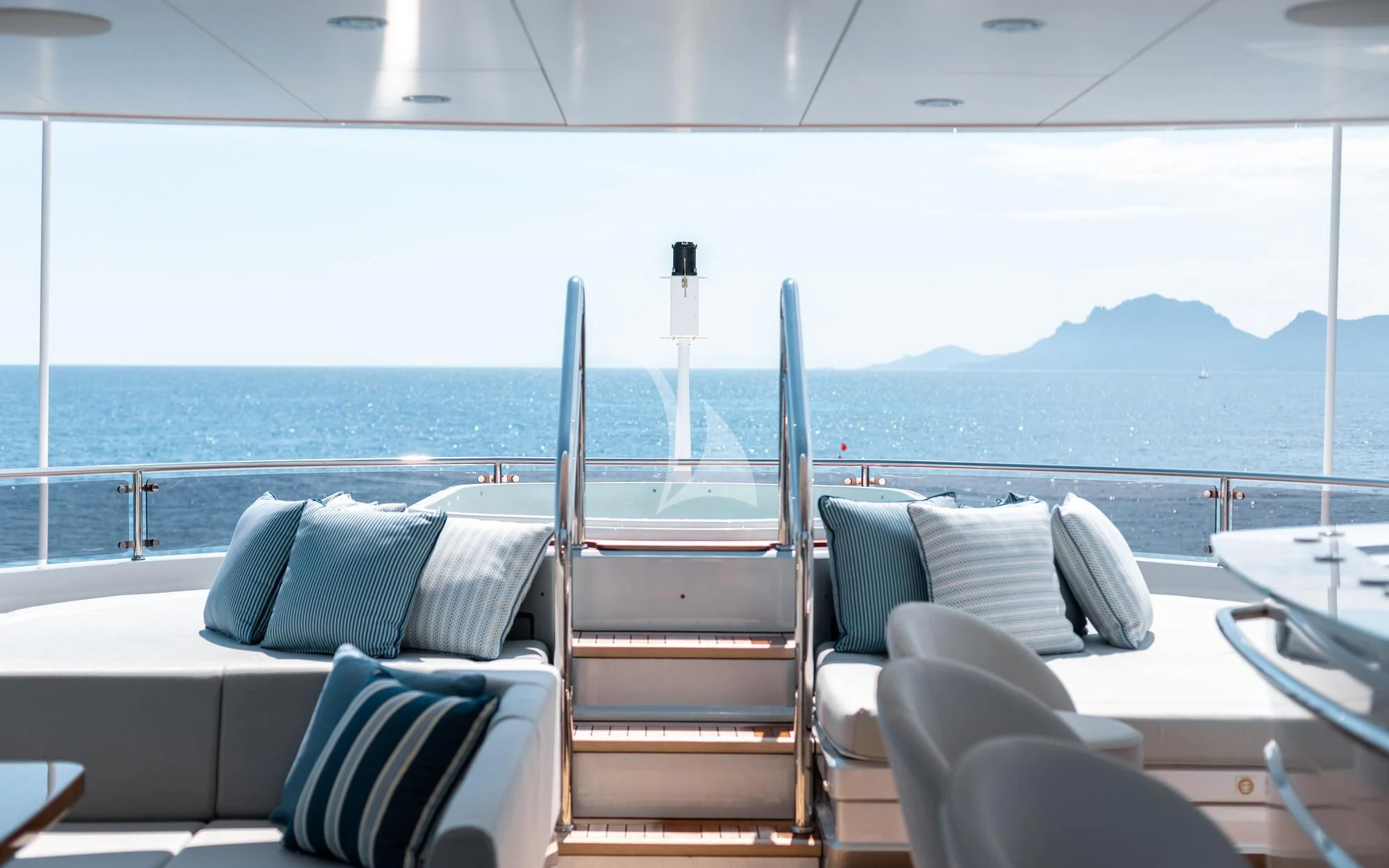 a deck with chairs and a railing aboard ARADOS Yacht for Charter
